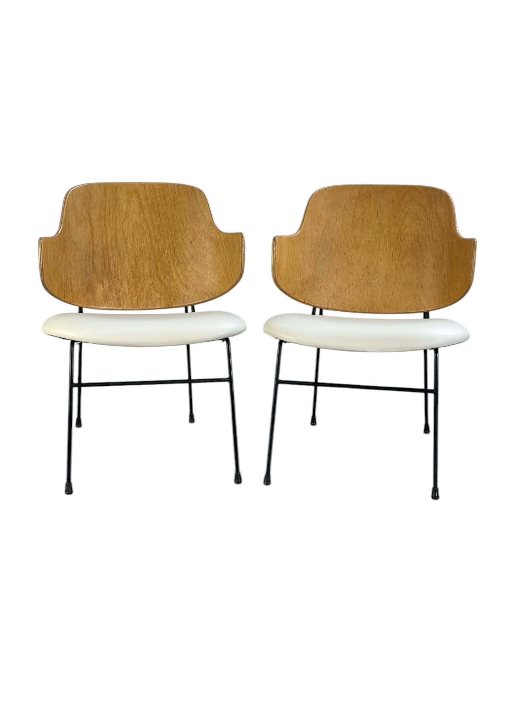 Pair of matching Penguin lounge chairs designed by Ib Kofod-Larsen. Superb example of Danish modern elegance. Birch wooden backs have been expertly refinished to showcase the beautiful color and wood grain patterns. The seats have been outfitted