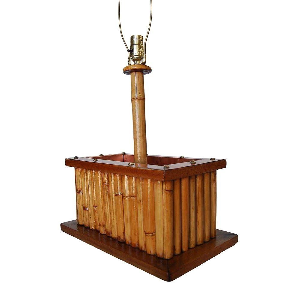 This beautifully rare restored rattan table lamp features a copper planter in the center with a Koa wood base, blending style and vintage charm with modern comfort. It takes one standard E26 American light bulb and is wired with a 120V US plug. The