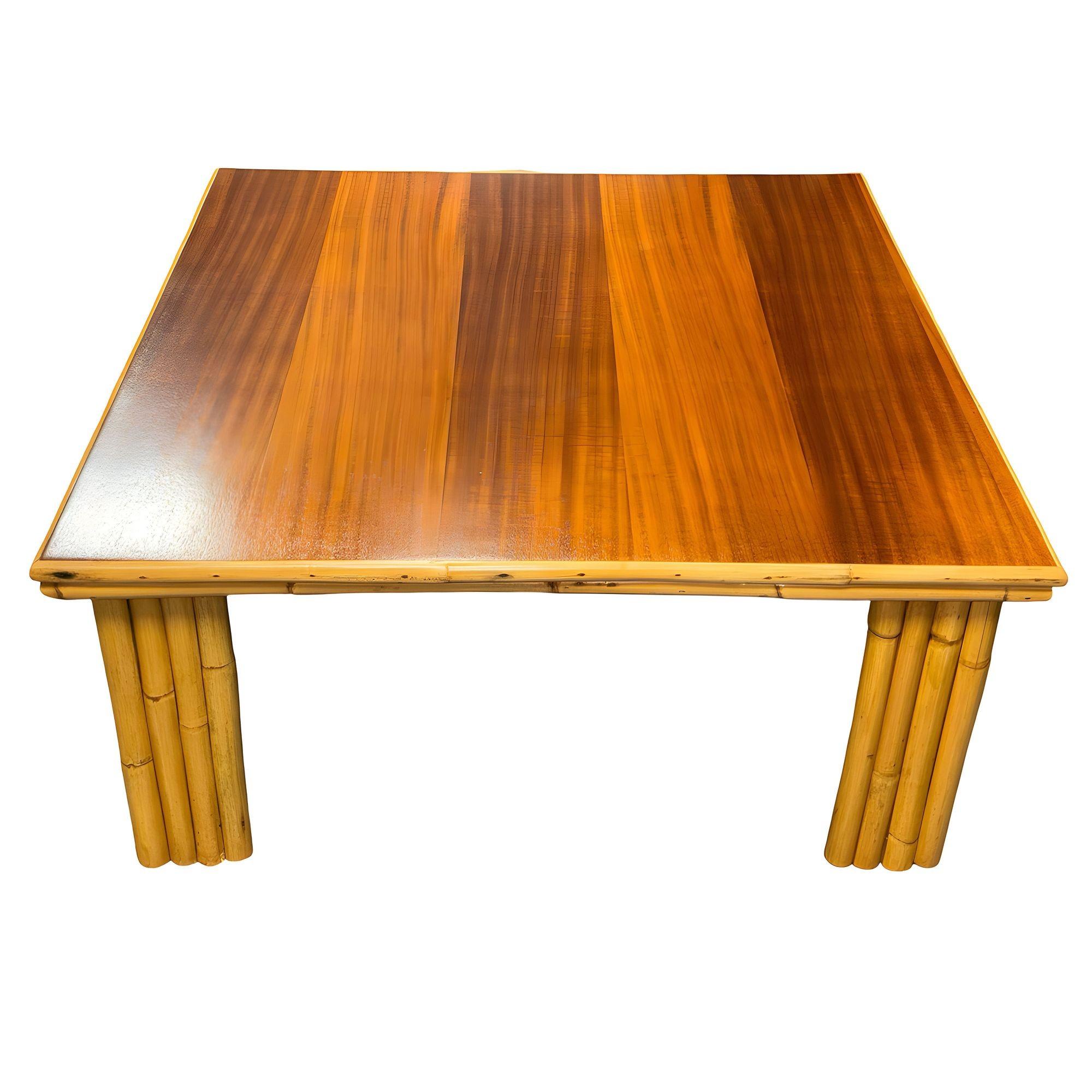 Restored rattan & curly mahogany square coffee table with vertically stacked rattan legs. The table features a large mahogany top decorated with 2 strand rattan trim and rests on 4 corner-shaped legs made up of 7 vertically stacked rattan poles.