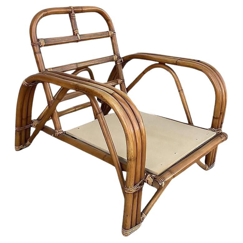 Chaise longue à bras "Staple" en rotin restauré, teinté foncé, à trois brins