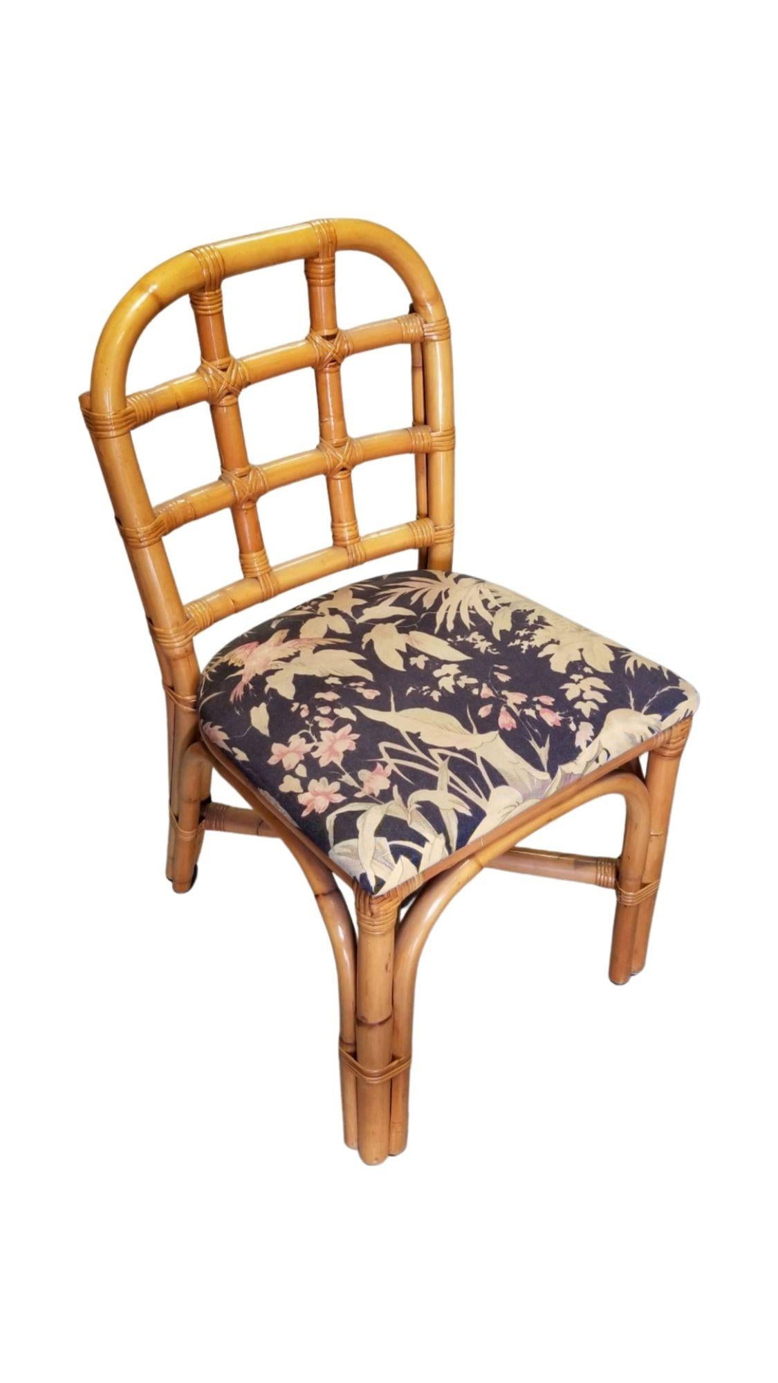 Restored rattan dining side chairs with Tic-Tac-Toe grid back and vintage tropical floral seat.

1950, United States

We only purchase and sell only the best and finest rattan furniture made by the best and most well-known American designers and
