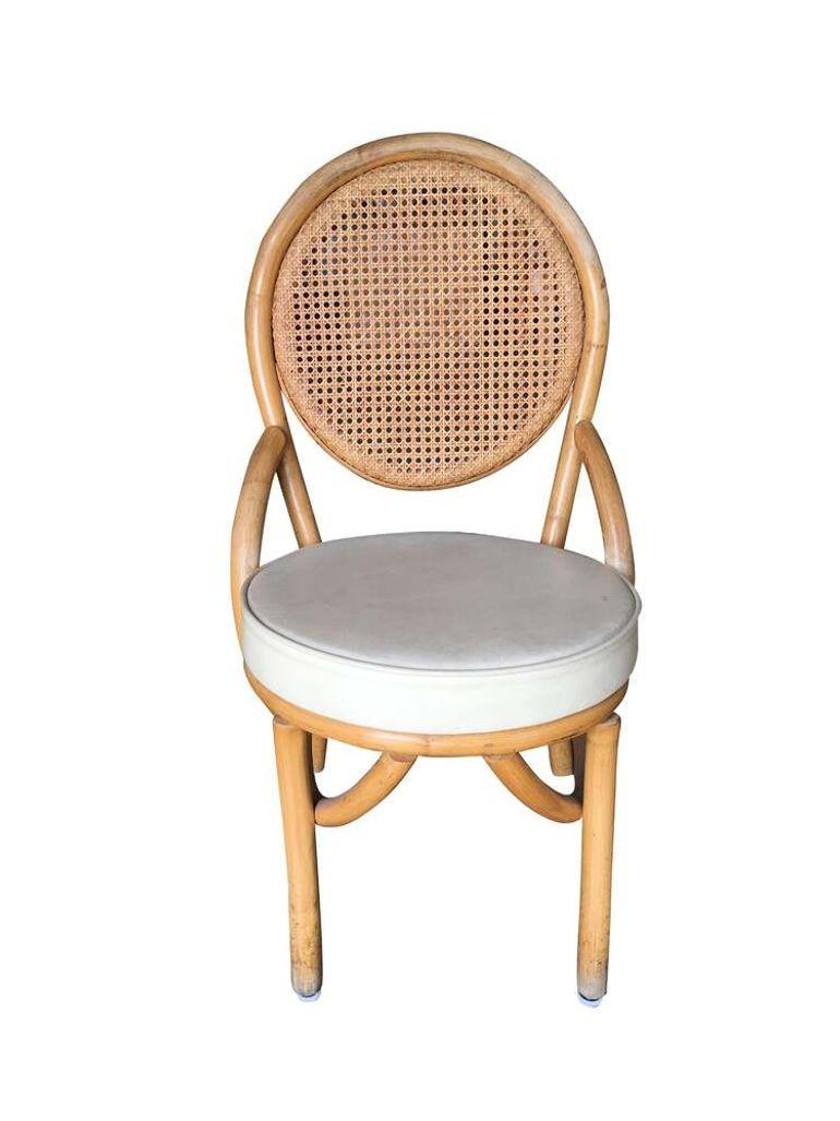 Set of Six Post-war 1950s rattan dining side chairs with woven wicker seat back and white vinyl seat.

We only purchase and sell only the best and finest rattan furniture made by the best and most well-known American designers and manufacturers
