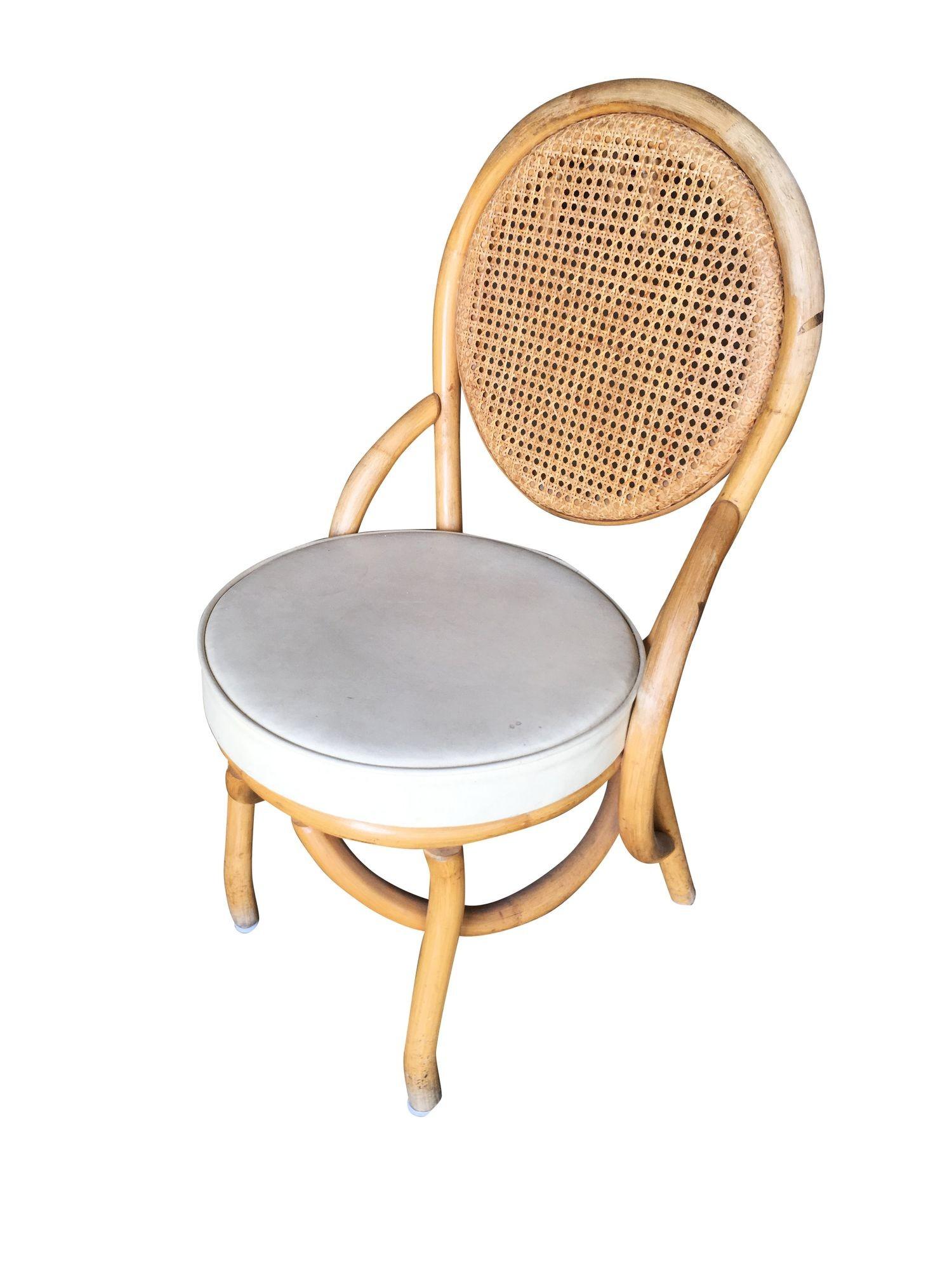 Set of Six Post-war 1950s rattan dining side chairs with woven wicker seat back and white vinyl seat.
We only purchase and sell only the best and finest rattan furniture made by the best and most well-known American designers and manufacturers