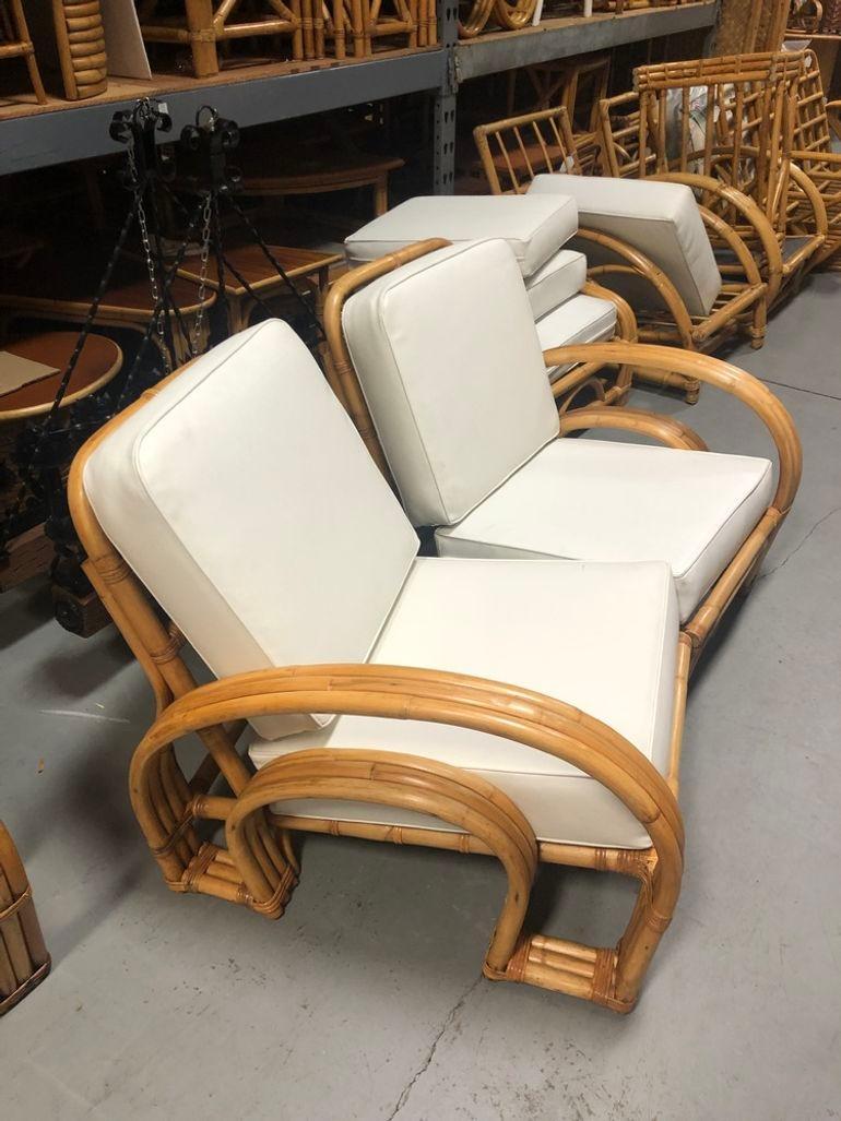 This restored mid-century rattan Double Horseshoe arm settee showcases timeless charm with its vintage appeal. Crafted with solid construction and three-strand arms, it exudes both elegance and durability, epitomizing the iconic design of