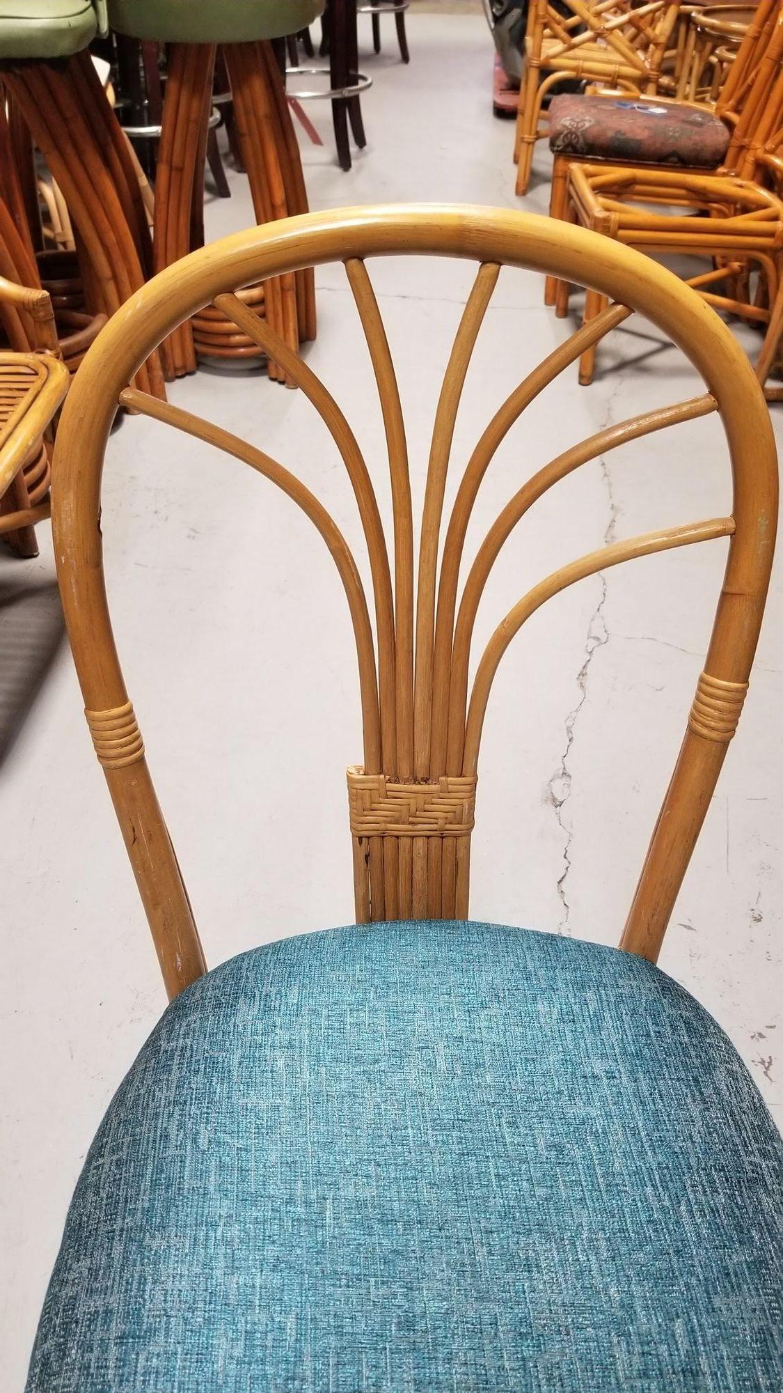 Pair of 1980s postmodern fan back rattan dining or accent side chairs in teal blue seat cushions.

Circa 1980s

We only purchase and sell only the best and finest rattan furniture made by the best and most well-known American designers and