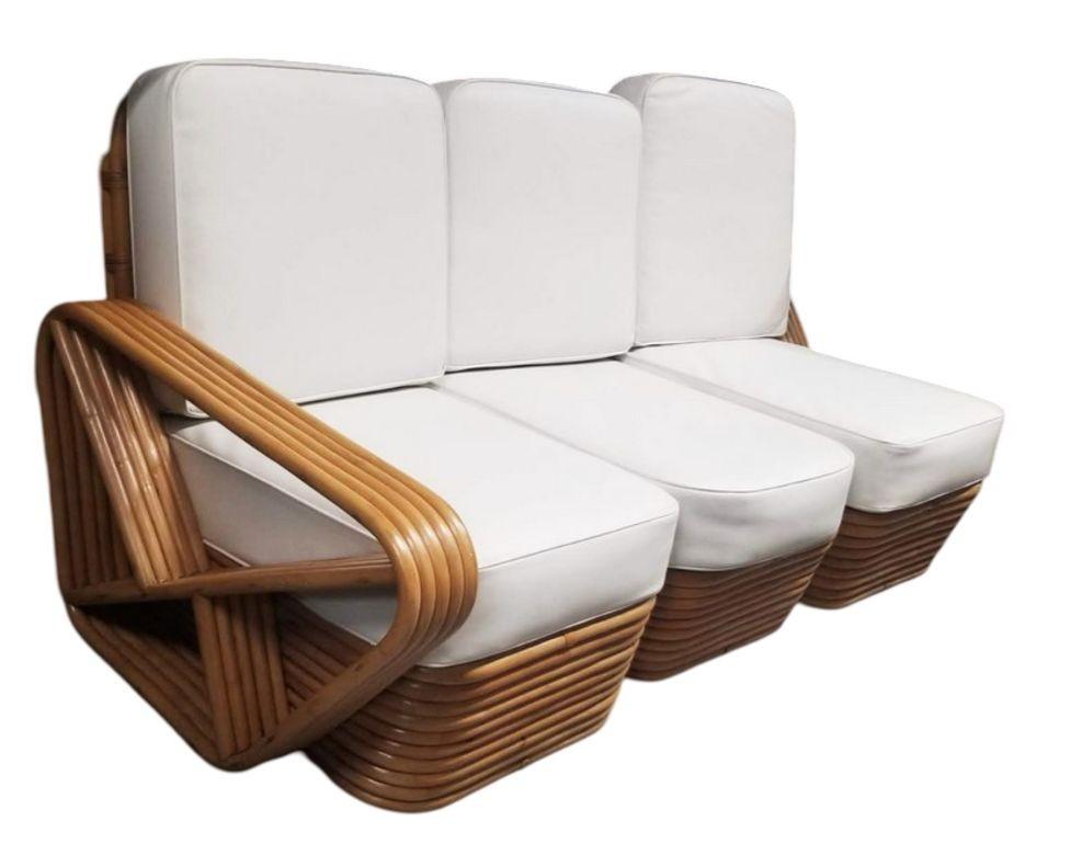 This beautifully restored Paul Frankl-inspired Rattan Five-Strand Square Pretzel Sofa and Lounge Chair Set

Description
A fully restored living room set featuring a five-strand square 3/4 pretzel three-seat sectional sofa and matching lounge
