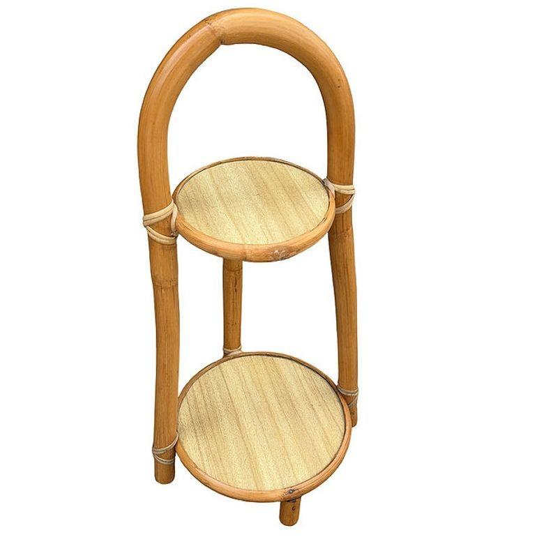 This beautifully restored rattan drink stand blends style and vintage charm with modern comfort. A charming example of mid-century tropical design, this restored 1950s rattan drink stand features a sleek Formica top and lower shelf, framed by