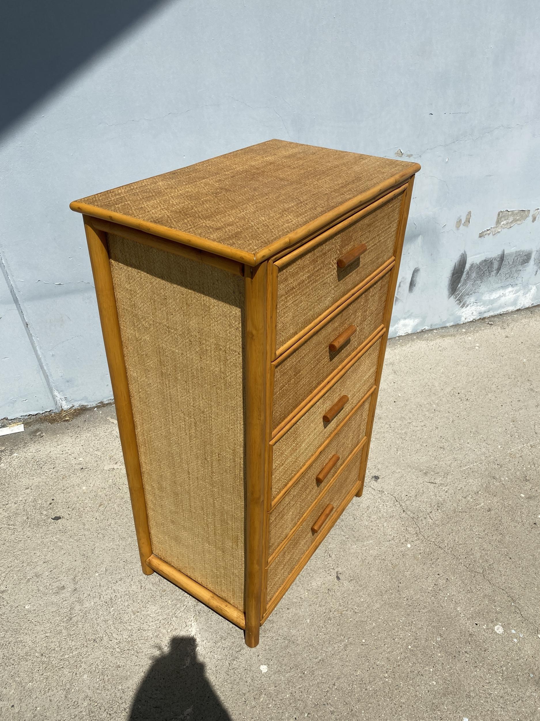 Mid century highboy boy chest of drawers with handwoven rice mat coverings, five large center drawers and rattan border.

Restored to new for you.

All rattan, bamboo and wicker furniture has been painstakingly refurbished to the highest
