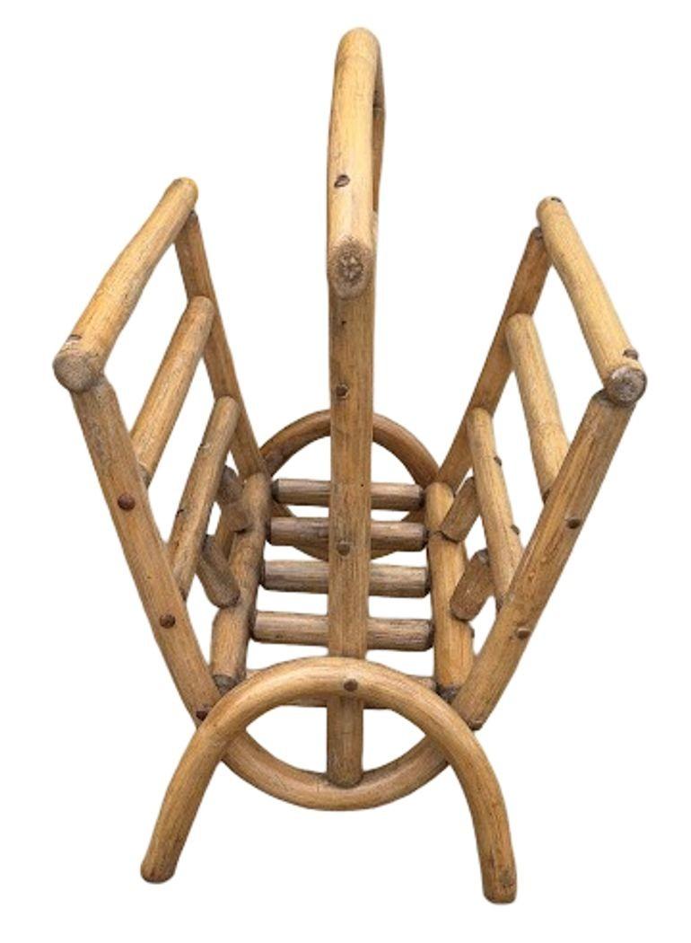 This beautifully restored mid-century rattan holder offers a versatile and stylish storage solution, ideal for magazines, newspapers, or small logs. Handcrafted with steam-bent rattan poles and curved supports, its organic form and honey finish
