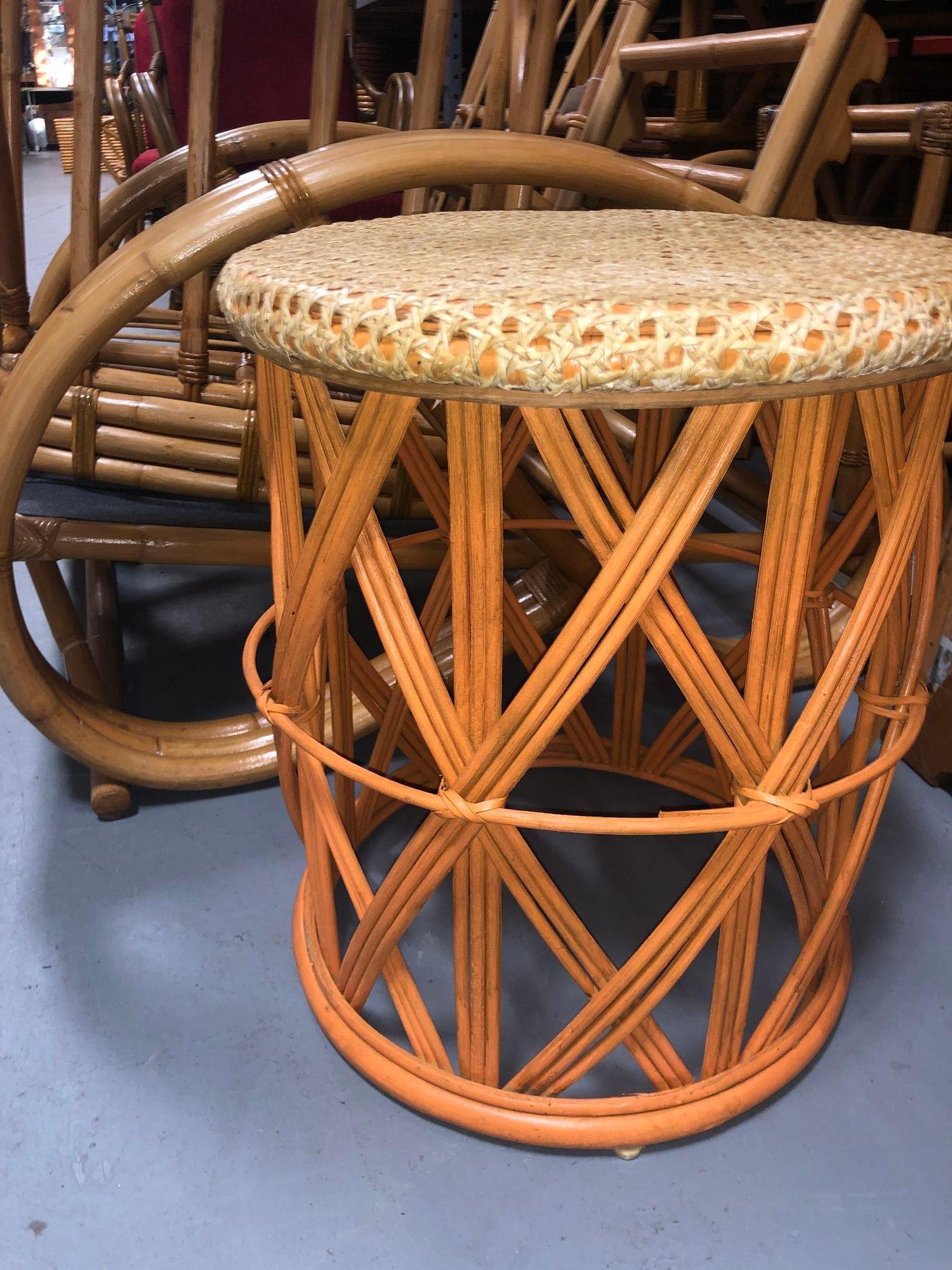 This restored rattan orange and natural cane table offers a stylish and versatile accent to any space. With its vibrant orange and natural cane top, it brings warmth and character to the room. Perfect as a side table or a plant stand, it combines