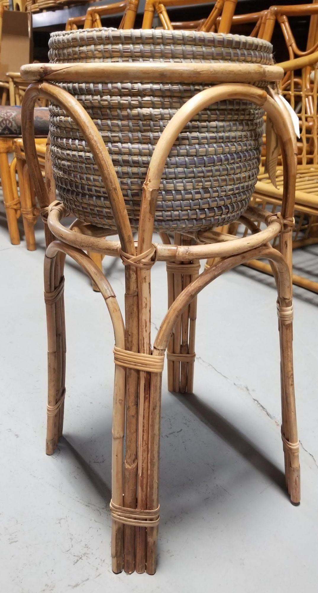 Restored rattan plant stand with a stone grey woven basket planter perfect for your indoor plant.

Circa 1950s.

We only purchase and sell only the best and finest rattan furniture made by the best and most well-known American designers and