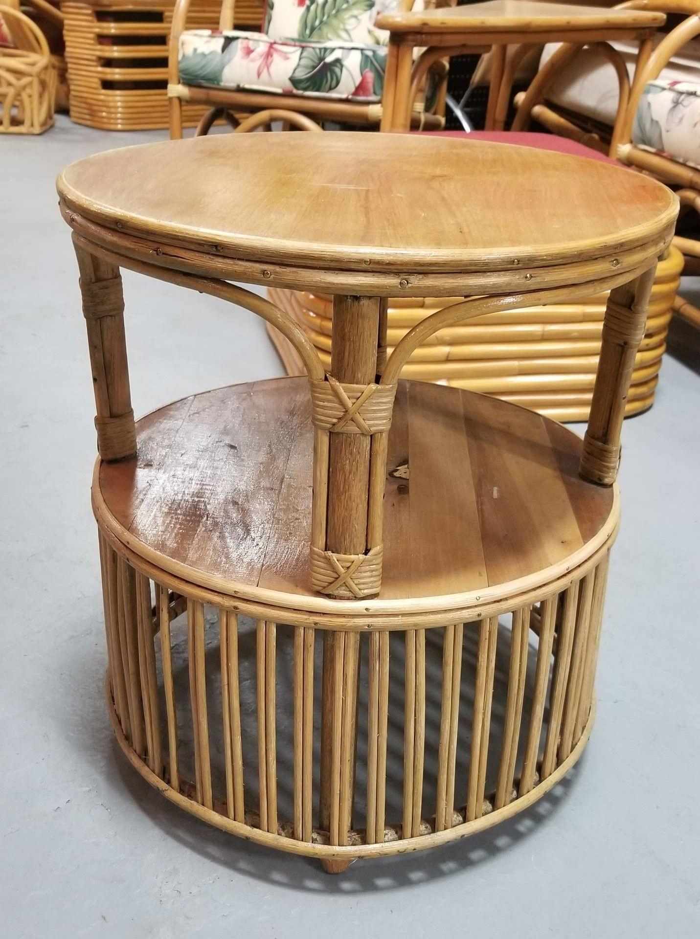 Restored mid-century rattan 2-tiered round side table with pencil reed drum style base. In the style of Gabriella Crespi.

Circa 1940, United States

We only purchase and sell only the best and finest rattan furniture made by the best and most