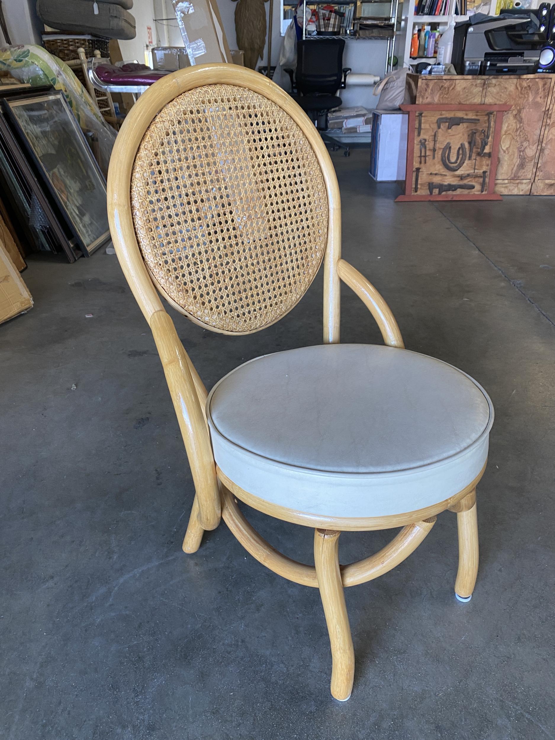 Set of 6 rattan and wicker side chair, the chair features a large round woven wicker seat back and round naugahyde cushion seat. 

Circa 1950

Tropical Sun Rattan was started in 1934 at 117 West Colorado Blvd in Pasadena. By 1938 we had