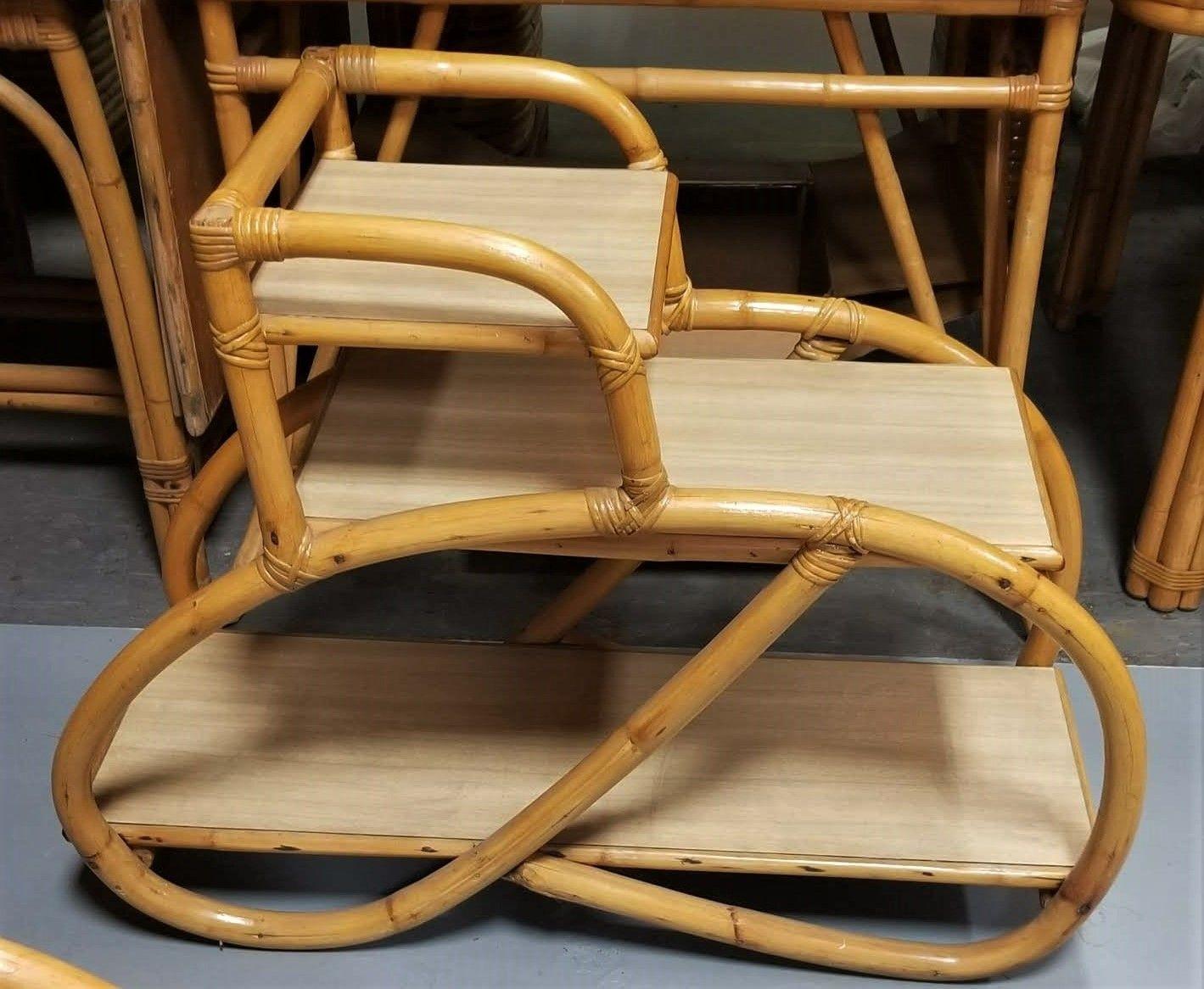 Rattan side table 3-tier of shelves with 1 strand 3/4 pretzel rattan arm and a soft beige Formica table top finish - Set of 2. Perfect alongside your bed or sofa.
Circa 1950, USA
We only purchase and sell only the best and finest rattan furniture