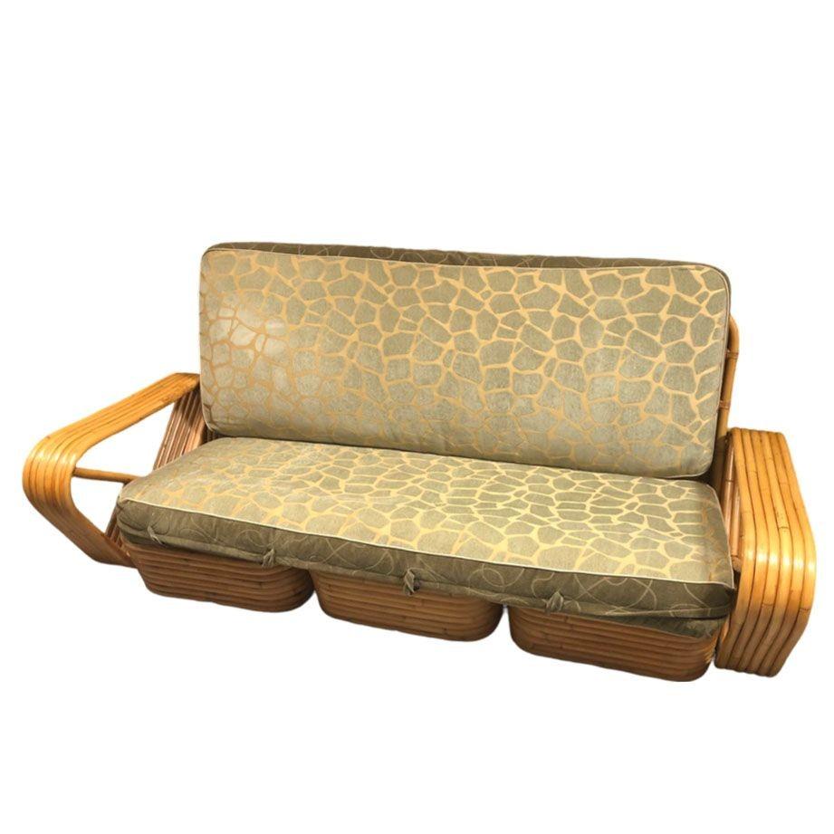 This restored Mid-Century Rattan sofa in three pieces featuring six-strand square pretzel arms showcases timeless charm styled after the design made famous by Paul Frankl. Crafted with solid construction and six-strand arms, it exudes both elegance