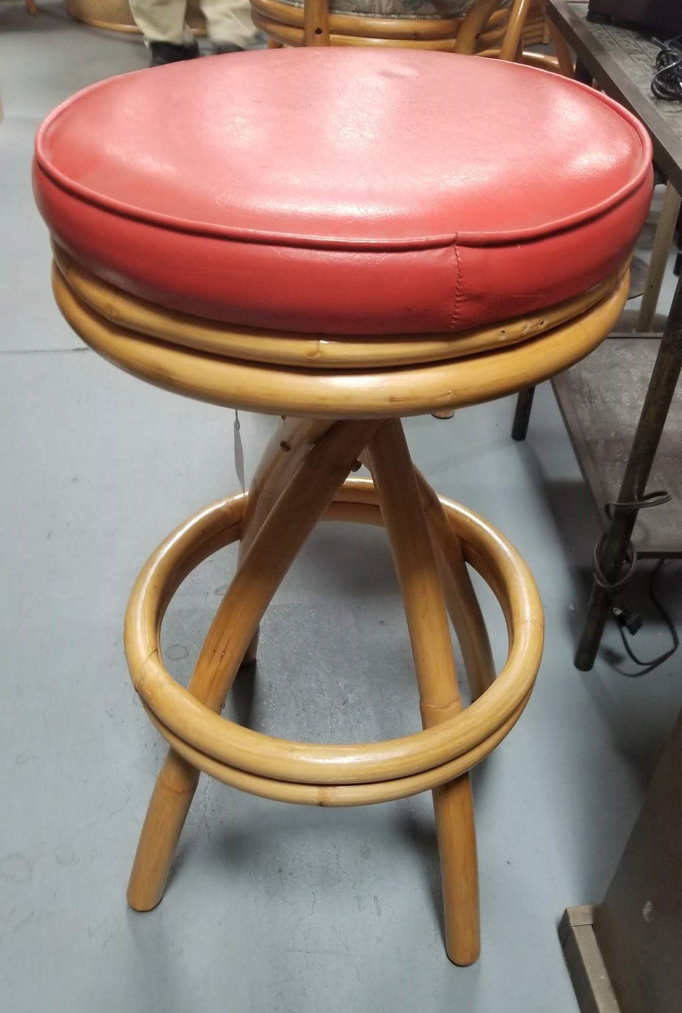 Restored single-stand spiral leg bar stools with a double stacked bottom footrest and swivel red seats.

Seat Height: 30