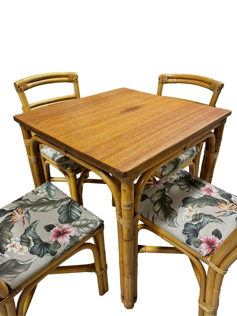 A stunning dining set that embodies timeless elegance and mid-century charm. This restored set showcases a square rattan table adorned with exquisite side wrappings and supported by five-strand legs, all complemented by the rich tones of Sapele