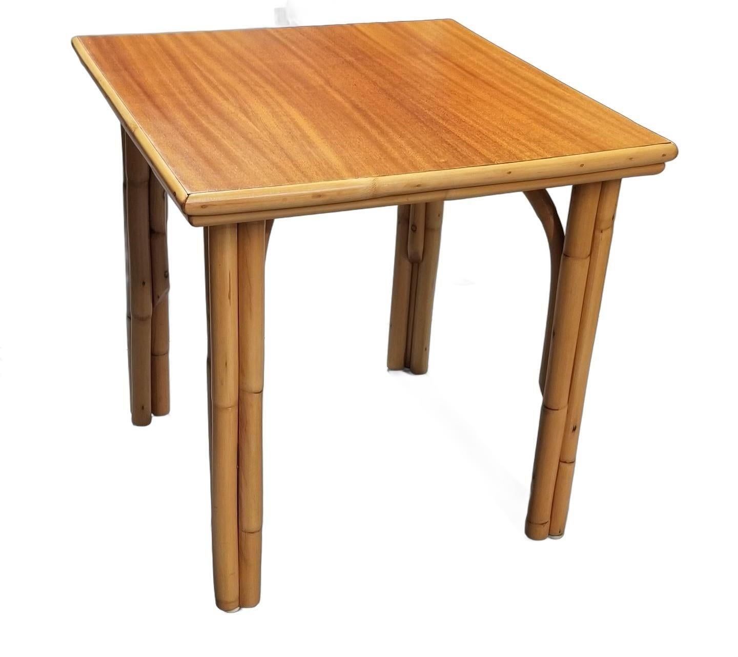 This beautifully restored Paul Frankl-inspired rattan Three-Strand Coffee Table, featuring gracefully arched legs and a lustrous mahogany top. Its compact, square design makes it ideal for smaller spaces, infusing a touch of tropical charm into any