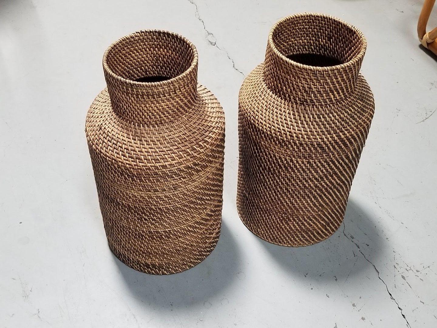 Small pair of Gabriella Crespi-styled decorative floor vases made from stacked reed pencil rattan rings with wicker weave. Perfect for holding dried plant arrangements or simply standing on its own.

Circa 1970, United States

We only purchase and