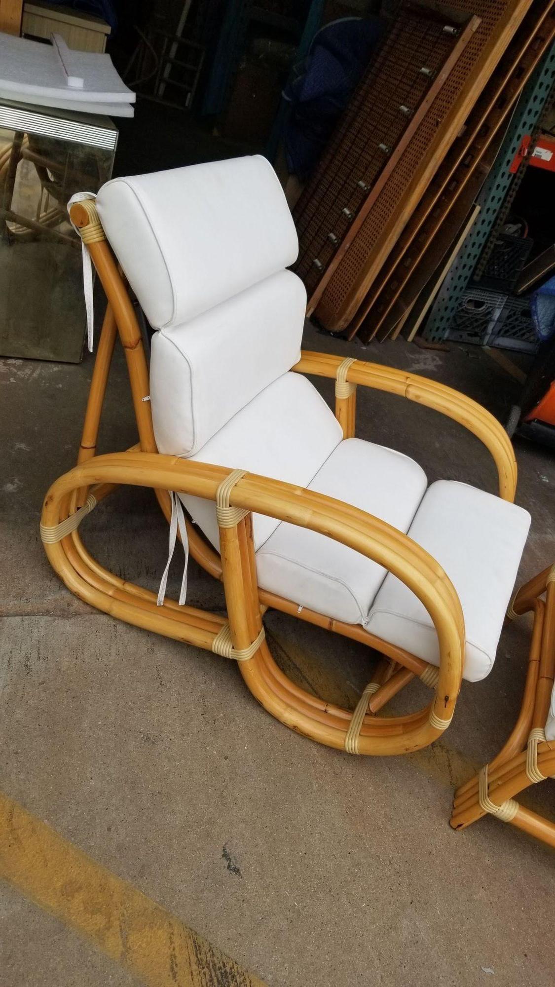 This immaculately restored three-strand rattan lounge chair and matching ottoman showcase the craftsmanship of a bygone era. The intricate rattan evokes a sense of nostalgia, while the restoration brings new life to the piece. With its elegant