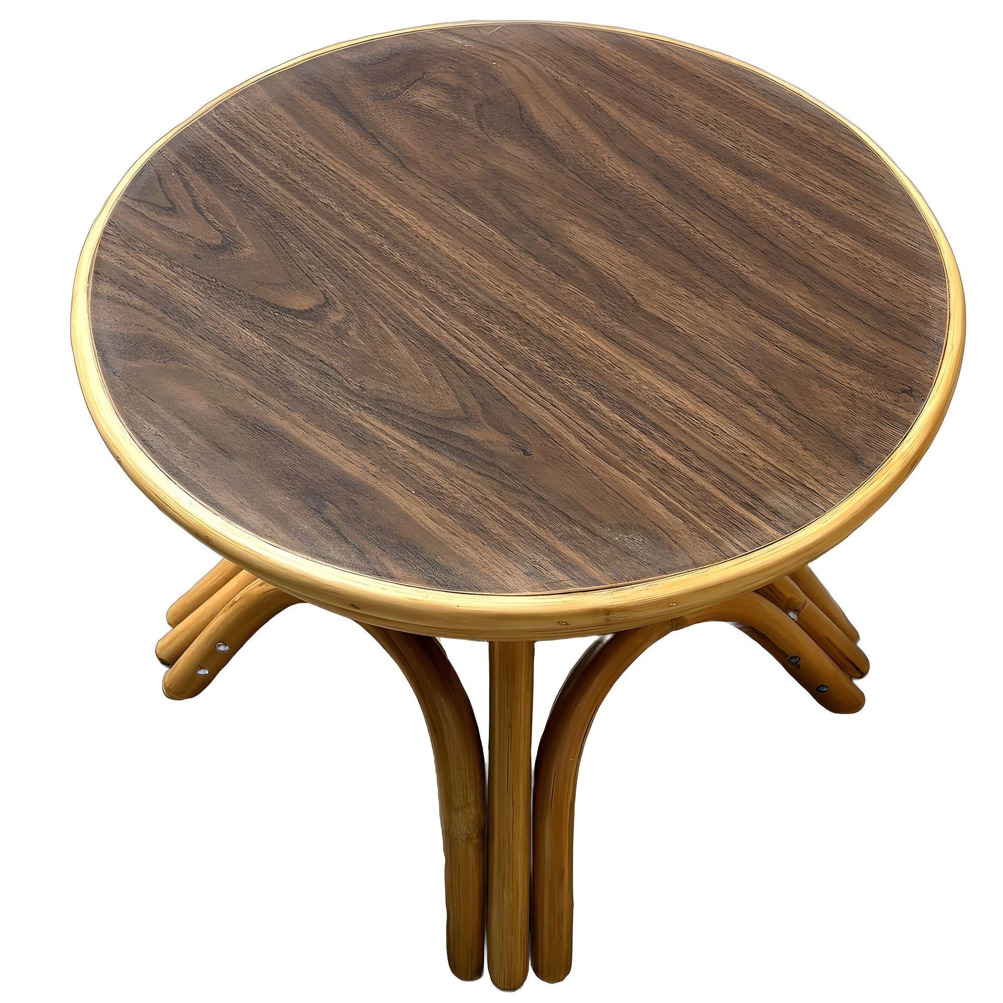 Restored round rattan coffee table, featuring wood grain Formica top and arched rattan base. This charming piece combines Mid-century design with Hawaiin charm, offering a stylish addition to any modern space. Perfect for compact areas with its low