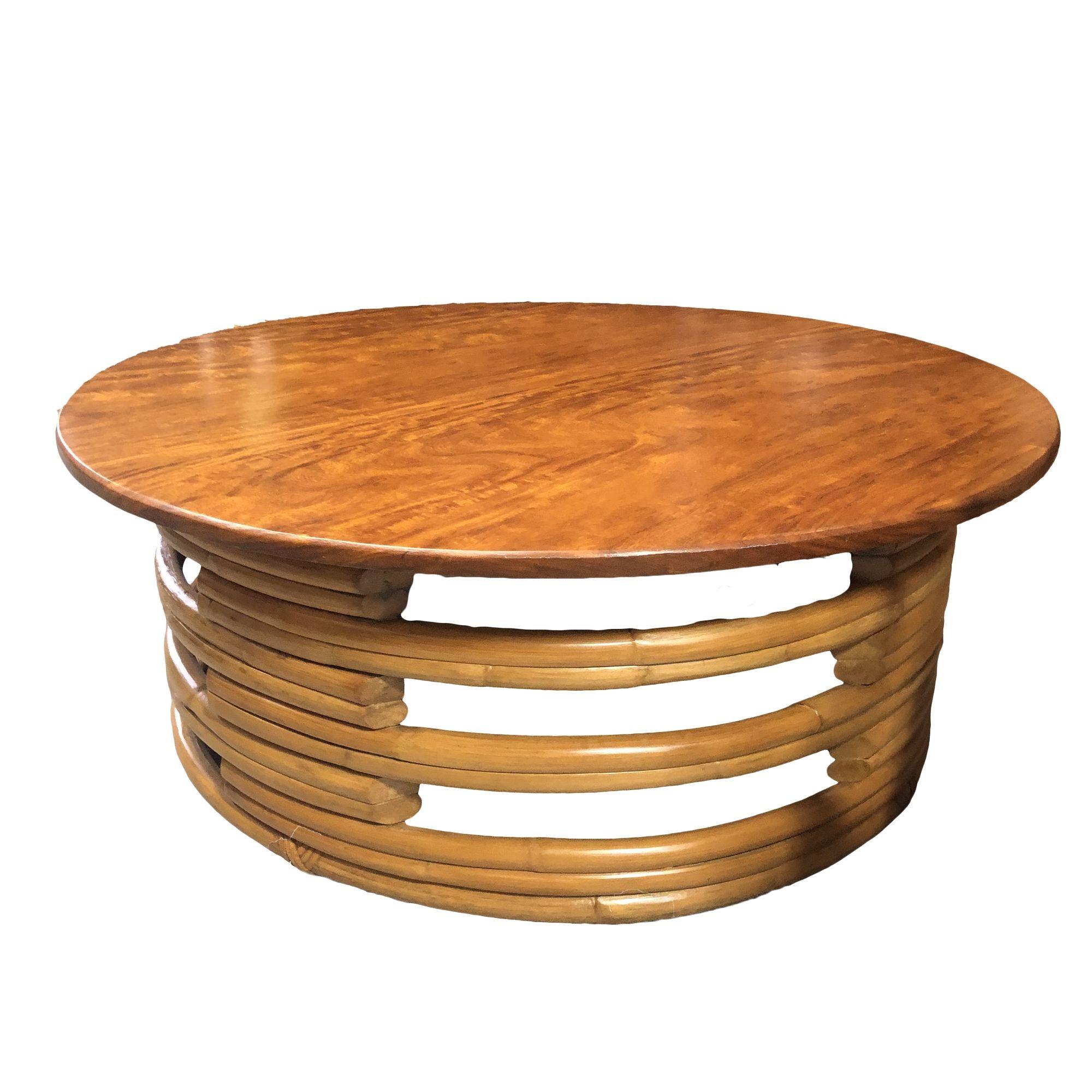 Stack round rattan coffee table, circa 1940. This rare rattan table features a unique stack rattan base made with cut-out sections which support the round Mahogany top.

Professionally restored to original specifications.

All rattan, bamboo and