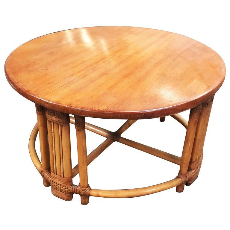 Round Mid-Century era rattan coffee table with five pole leg design and mahogany top. Please inquire about additional pieces available.  
We only purchase and sell only the best and finest rattan furniture made by the best and most well-known