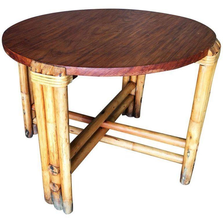 Pole round rattan coffee table. This rattan table features a unique pole rattan base with wicker wrappings and a solid mahogany top.

1950, United States

We only purchase and sell only the best and finest rattan furniture made by the best and most