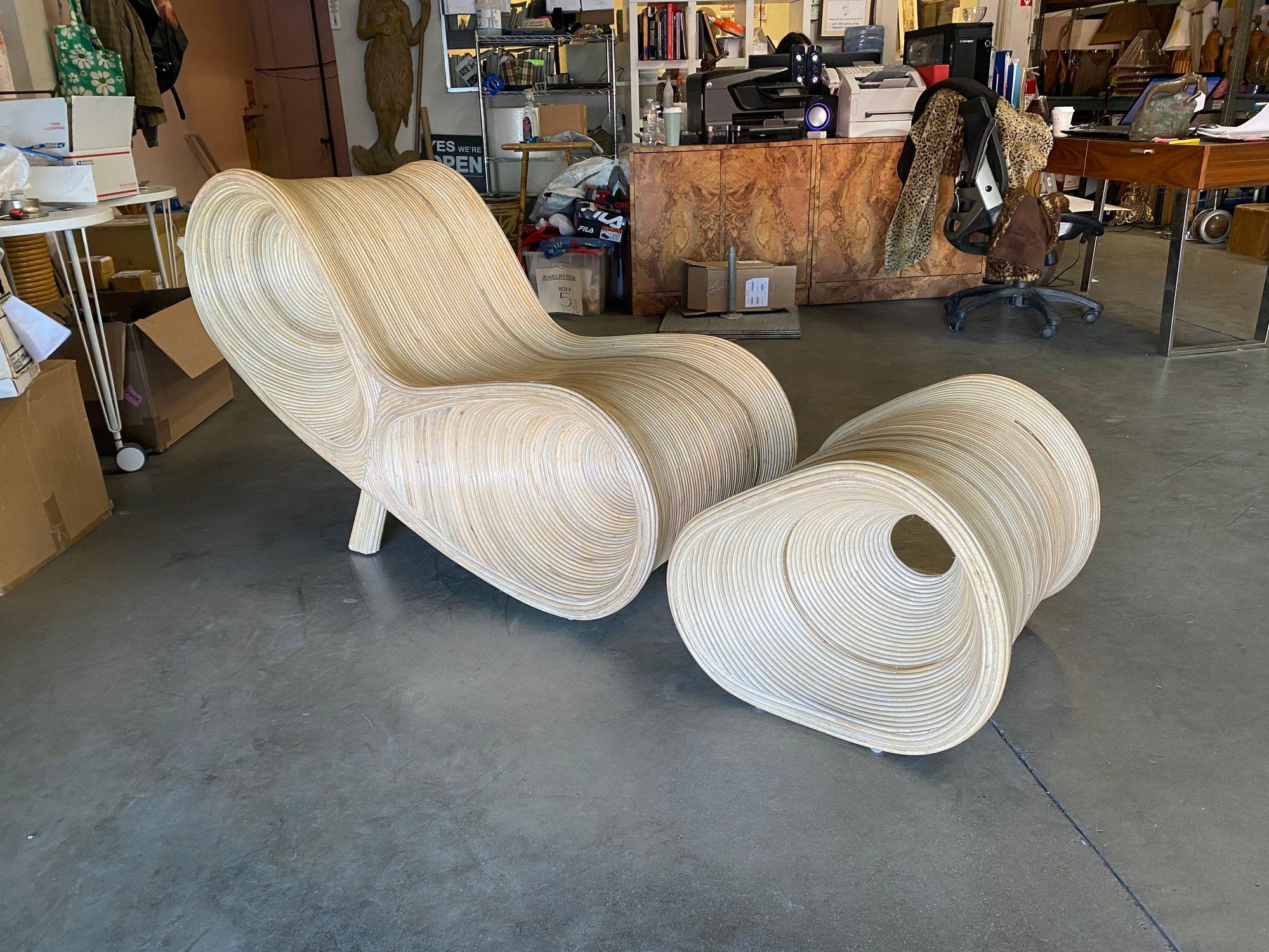 A gorgeous sculptural organic Post modern split reed rattan lounge chair with matching ottoman By Betty Cobonpue circa 1980 . This rare set includes the rounded  
