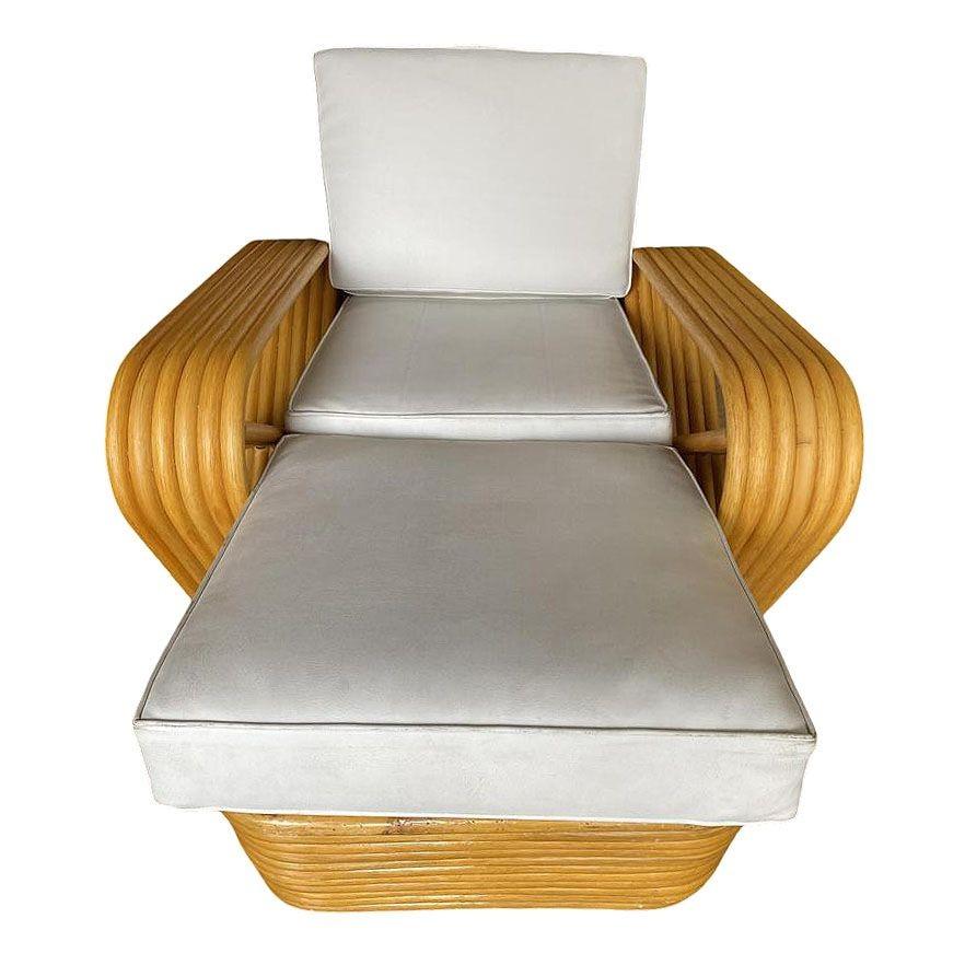 Designed in the manner of Paul Frankl, this beautifully restored six-strand, rattan chaise longue chair features square pretzel arms and a Classic stacked base blending style and vintage charm with modern comfort. The lounge is meticulously
