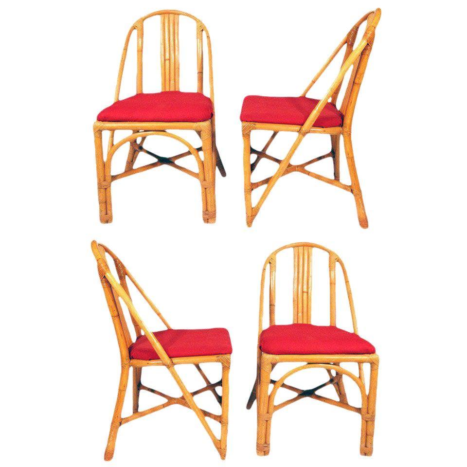 Vintage midcentury slat leg rattan dining room chair, included is a set of four side chairs and 2 matching armchairs. The side chairs feature a wonderful slanted slat design with the armchairs having the same design with an additional loop