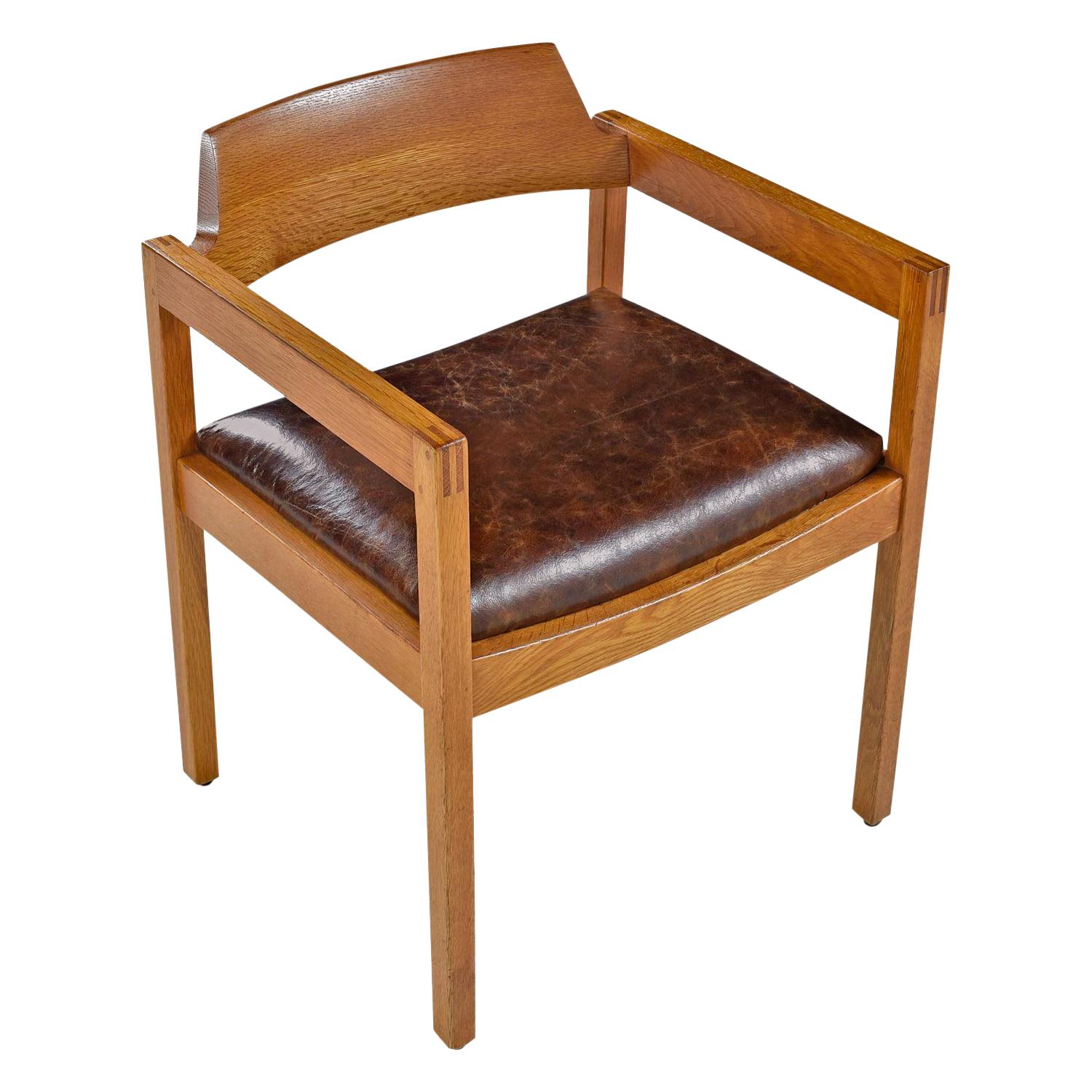 Solid oak frame has been restored by our in-house cabinet shop and re-upholstered in leather. Use the chair at the dining table, as a desk chair in the office or armchair in your living room arrangement. Stamped Gunlocke by the manufacturer.