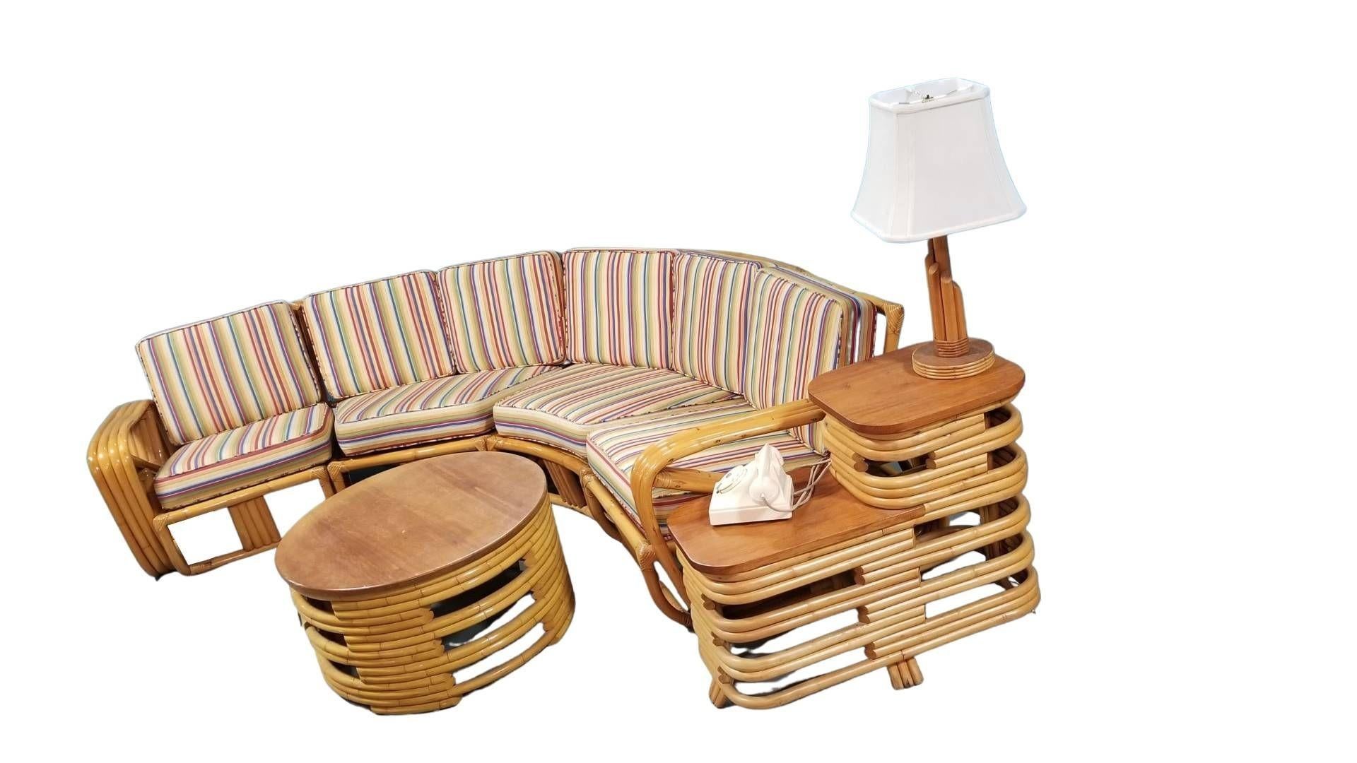 Mid-Century restored rattan living room set featuring a 4-piece sectional corner sofa with square pretzel arms, a round coffee table, and a two-tiered side table with included Bakelite telephone by Bell Systems

Lamp included, phone not
