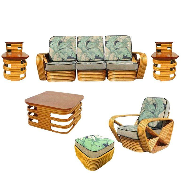 Rattan living room set includes a matching three-seat sectional sofa, lounge chair, ottoman, coffee table, and pair of end tables. Both the sofa and chair feature the famous six-strand square pretzel side arms and stacked rattan base originally