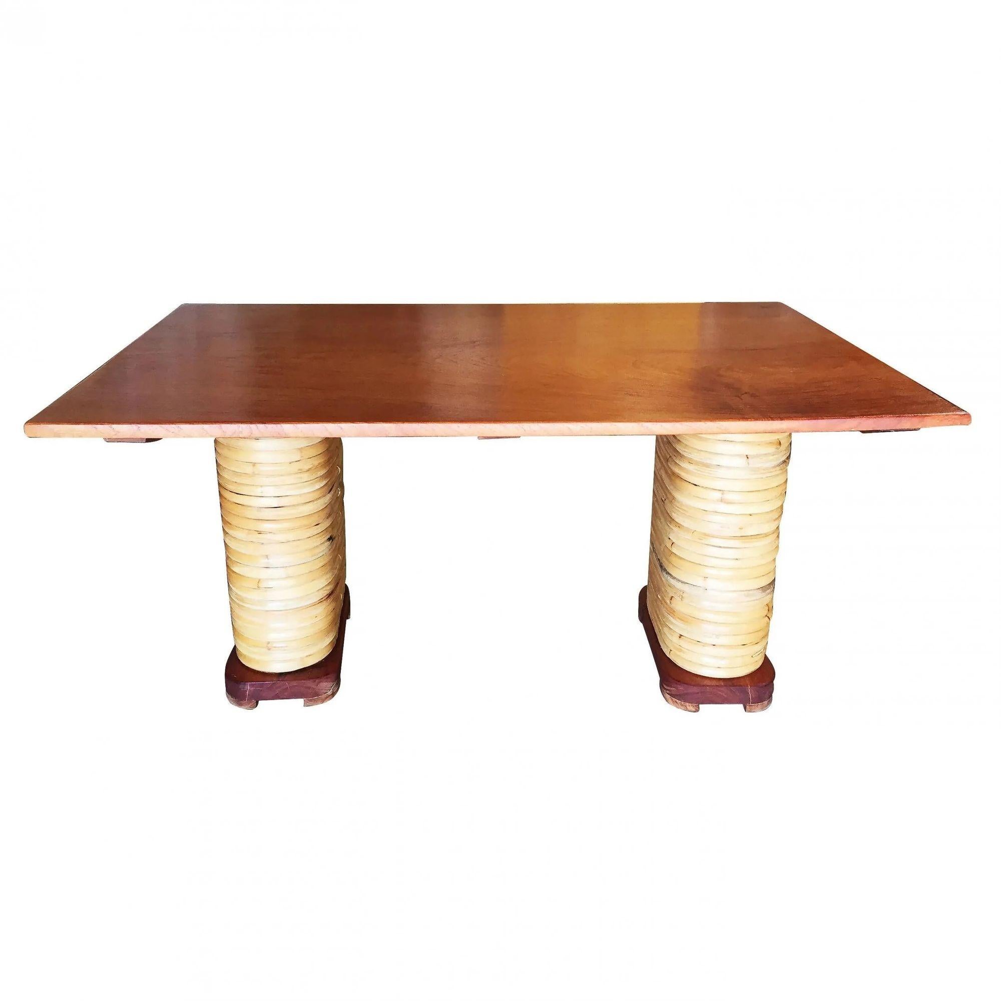 Midcentury six-person stacked rattan double mahogany dining table featuring 2 stacked rattan pedestal bases with solid mahogany feet and a mahogany table top. 
We only purchase and sell only the best and finest rattan furniture made by the best and