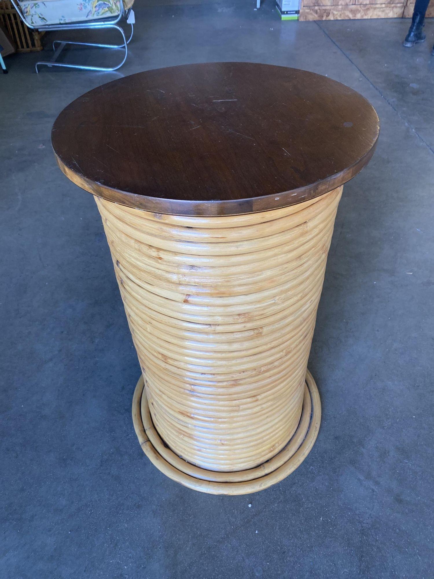 Original Post War stacked steam-bent rattan circular pedestal end table with a mahogany top. Perfect for display that key collector's piece.

1950, United States

We only purchase and sell only the best and finest rattan furniture made by the