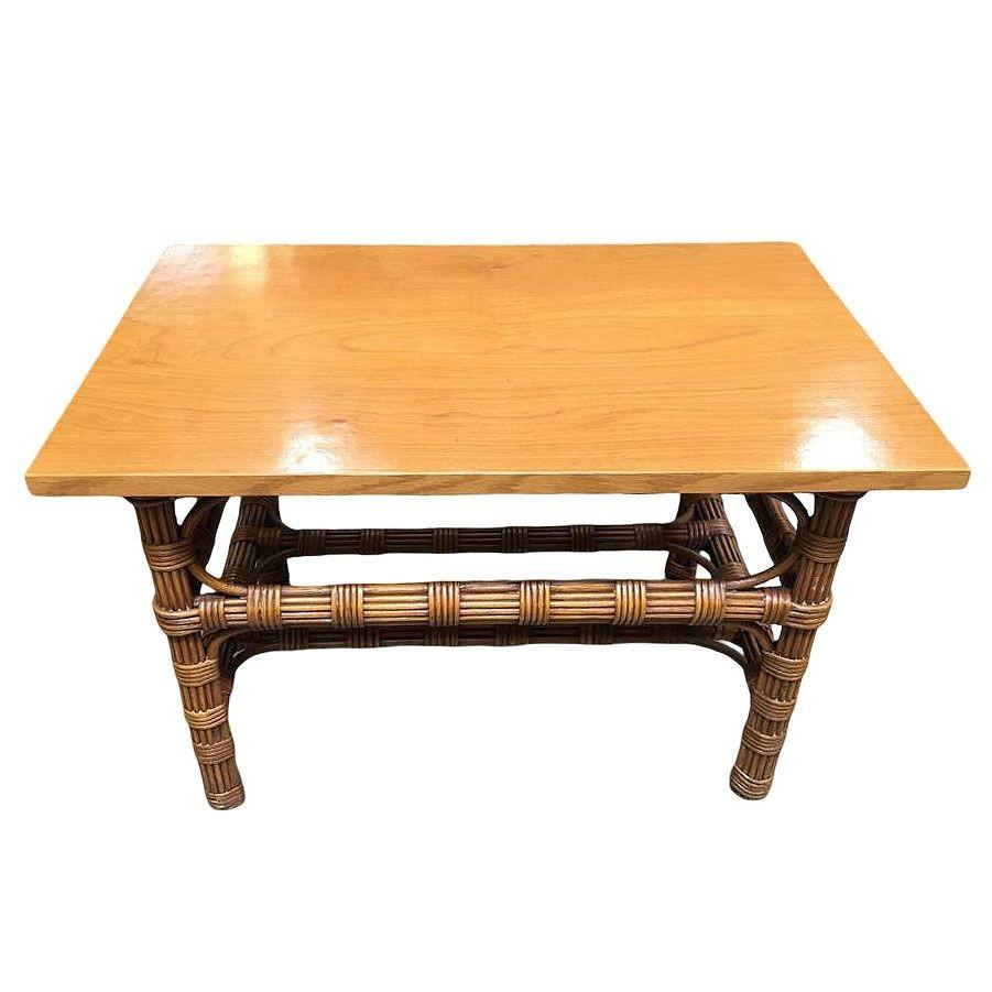 Stick rattan side table with bleached mahogany top featuring a unique wrapped stick rattan design. Restored to preserve its original charm, the table features a rich, solid mahogany top, offering a warm contrast to its natural rattan base that