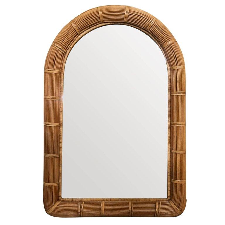 The mirror features a rectangle shaped frame with a decorative arch along the top accented by large rattan wrappings. 

North America, 1950.

Restored to new for you.

All rattan, bamboo and wicker furniture has been painstakingly refurbished to the