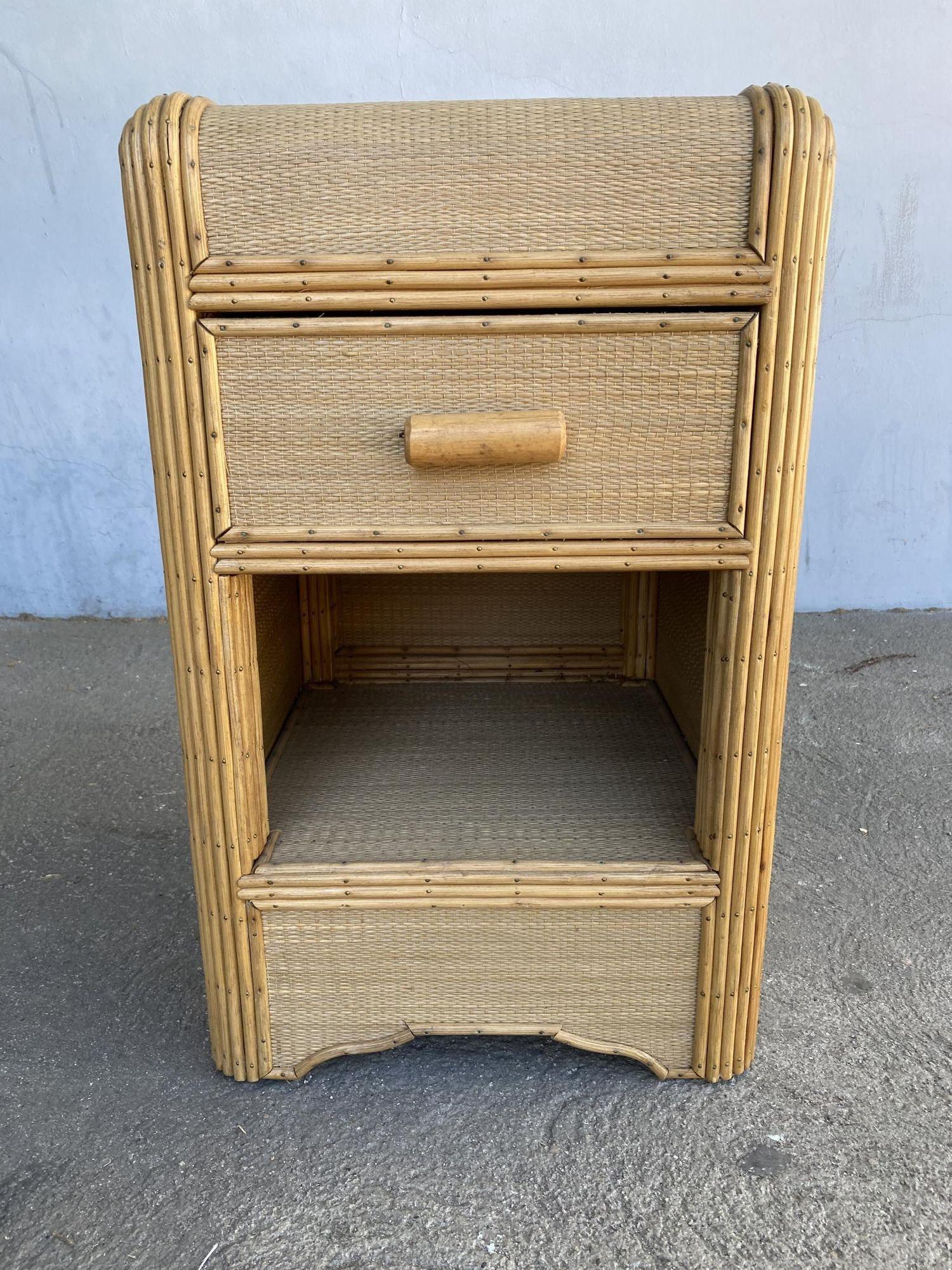 Streamline stick rattan side table with Grass-mat coverings, a Rattan pull handle, and edges are finished with brass nails.

1930, United States

Designed in the manner of Paul Frankl.

We only purchase and sell only the best and finest rattan