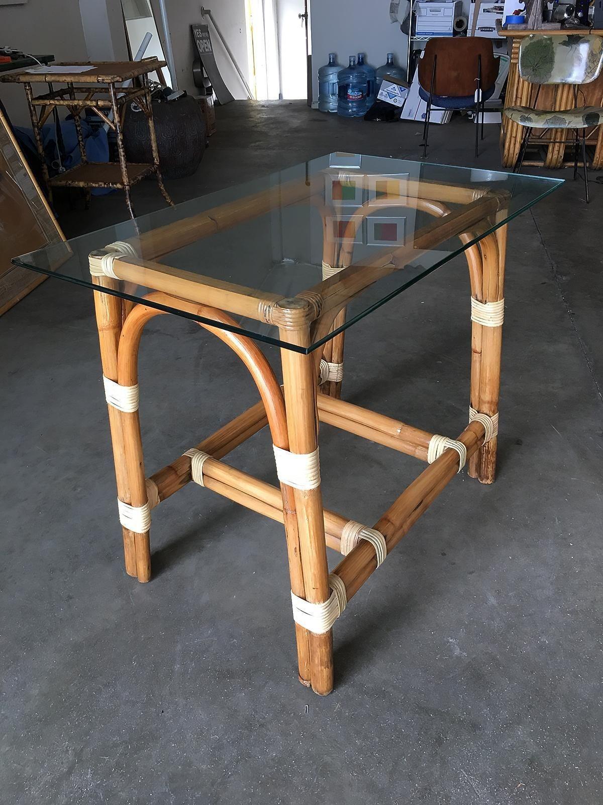 Restored rattan side table with a glass top. The table features wicker-wrapped accents with unique bent-pressed legs.

1950, United States

We only purchase and sell only the best and finest rattan furniture made by the best and most well-known