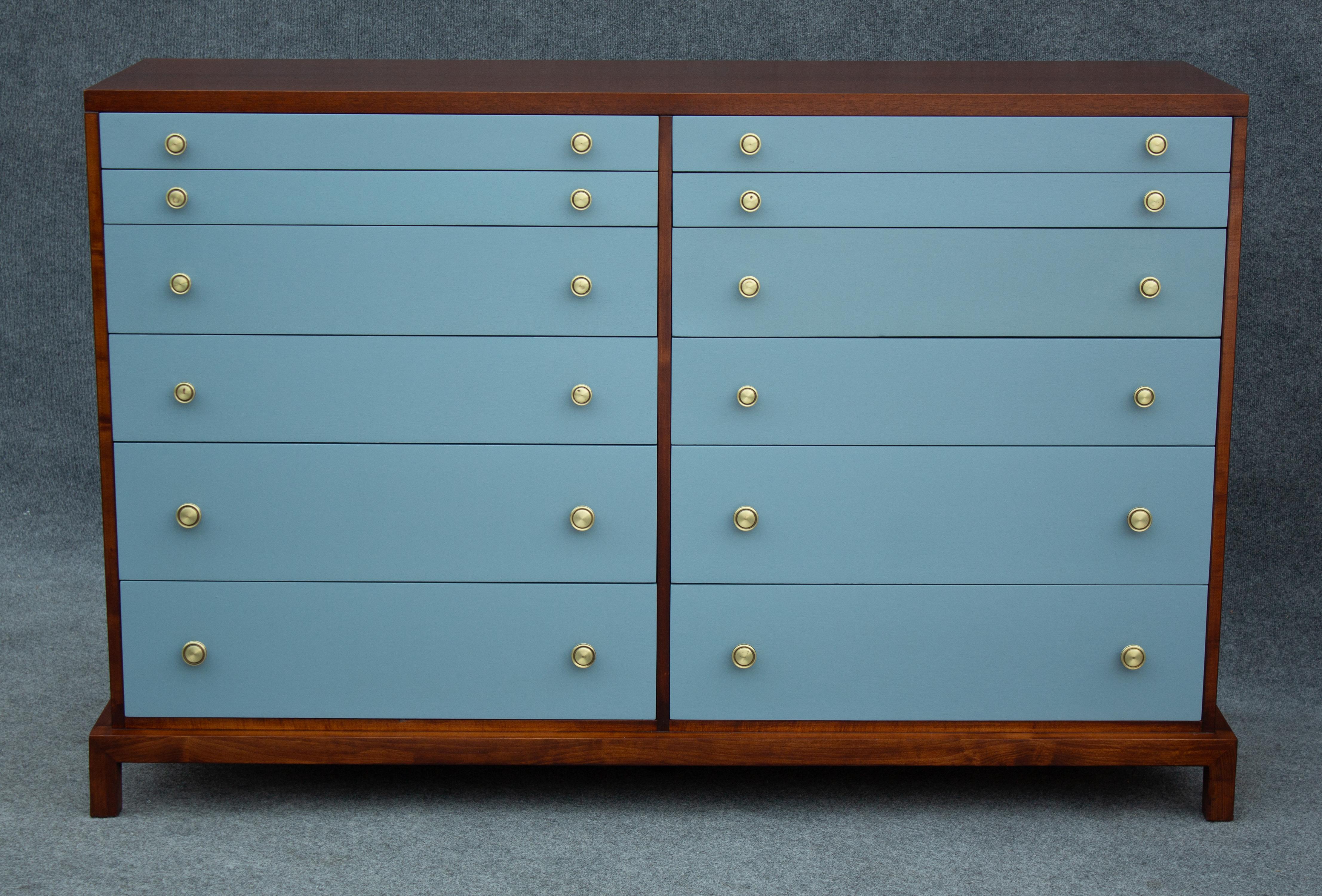 Designed by American design legend T. H. Robsjohn-Gibbings, this dresser was made by Widdicomb for distribution by John Stuart Inc. Typical of pieces by these groups, the construction quality on this dresser is extremely high. The finely grained