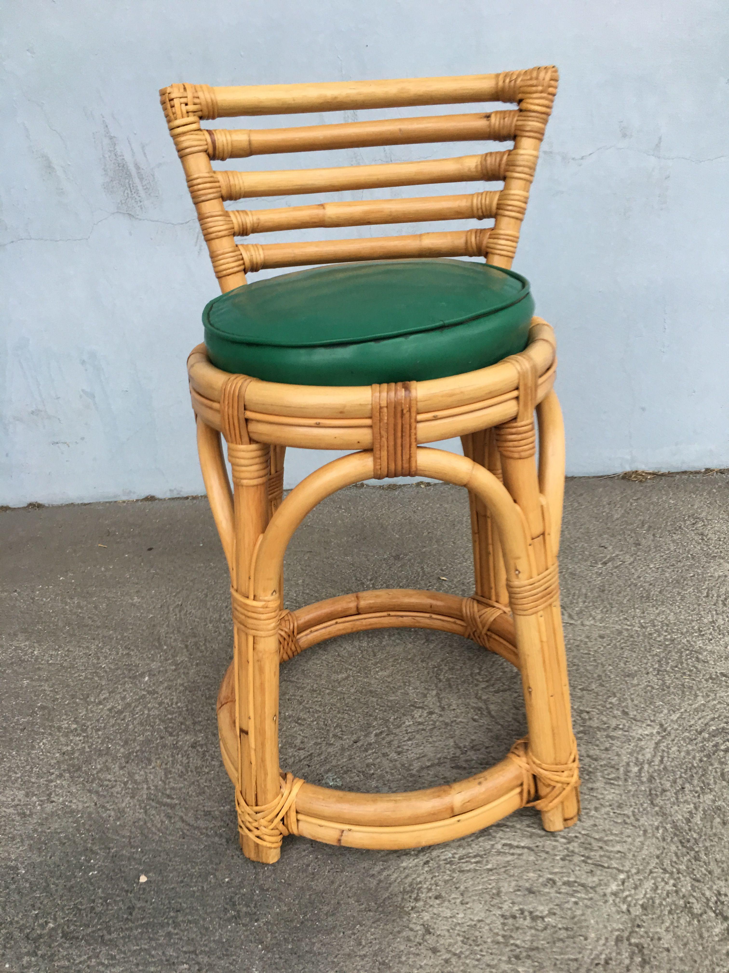 Restored three-stand rattan vanity stool with green vinyl seat and five-strand seat back. Restored to new for you. All rattan, bamboo and wicker furniture has been painstakingly refurbished to the highest standards with the best materials. All