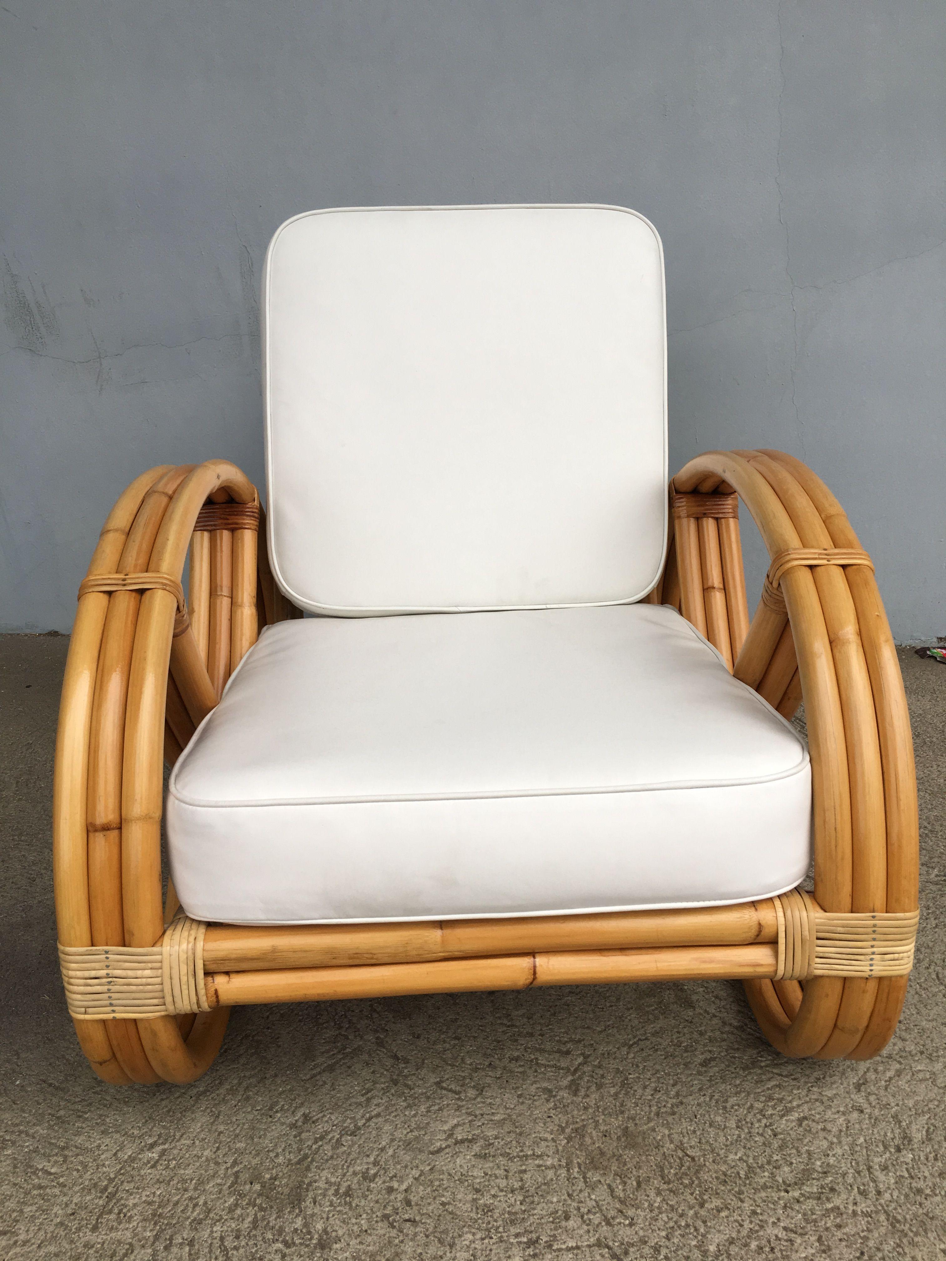 Rare three-strand round full pretzel arm rattan lounge chairs with fancy wicker wrappings. Designed in the manner of Paul Frankl. Restored to new for you. All rattan, bamboo and wicker furniture has been painstakingly refurbished to the highest