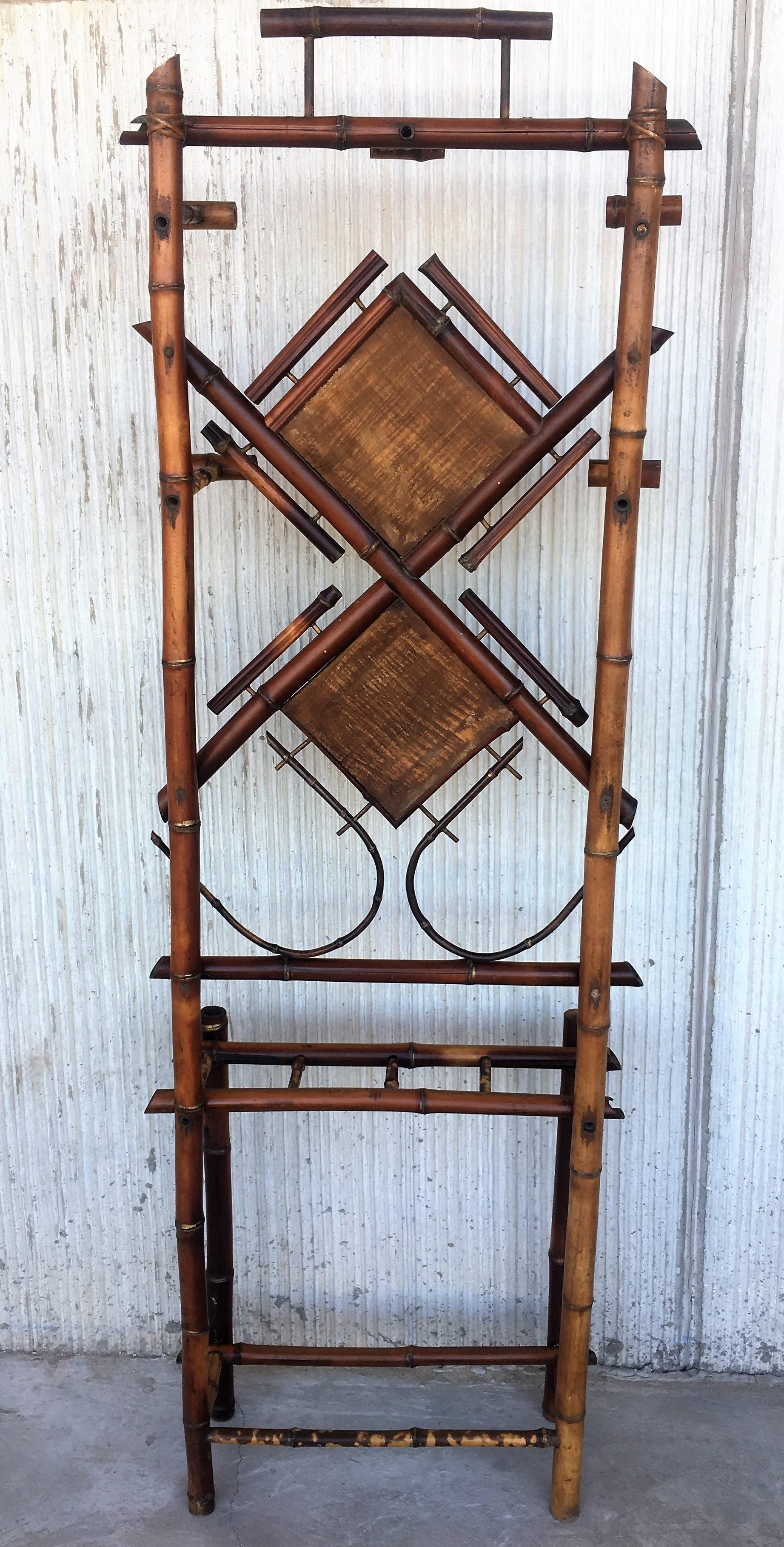 Antique tiger bamboo hall tree with handwoven rice mat and double decorative square/diamond center pieces. The hall tree features four slots for storing umbrellas and a vanity mirror and five hooks for coats.

Refinished to new for you.