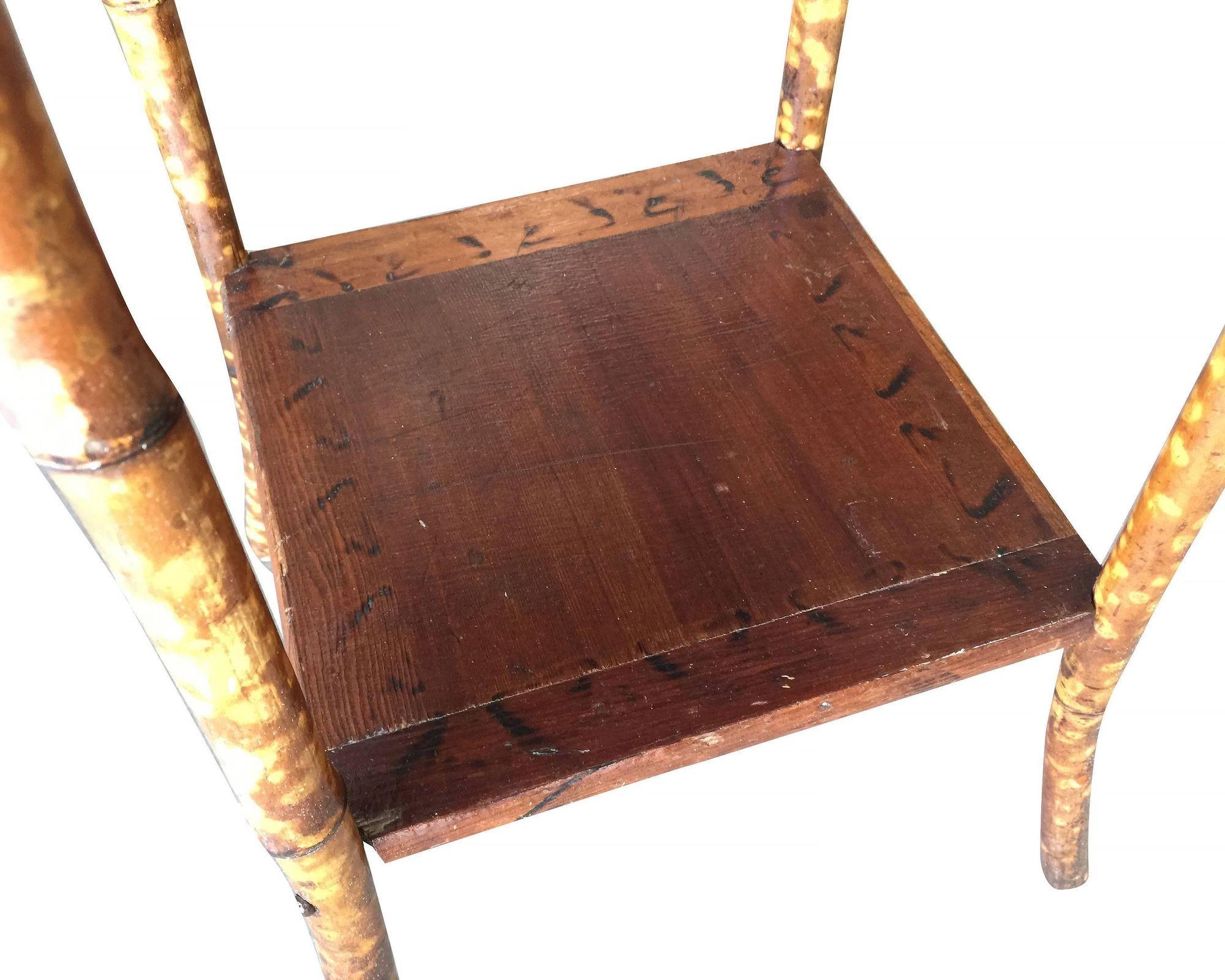 Antique tiger bamboo pedestal side table with rice mat top with flip-open lid storage and a secondary bottom shelf.
1950, United States
We only purchase and sell only the best and finest rattan furniture made by the best and most well-known American