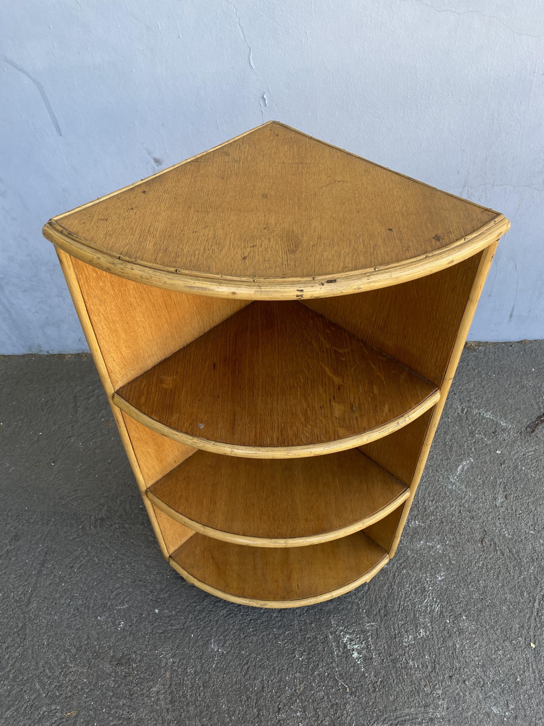 Original 1930s wood corner shelf with rattan border with 4 tiers. 

Designed in the manner of Paul Frankl.

Restored to new for you.

All rattan, bamboo and wicker furniture has been painstakingly refurbished to the highest standards with the