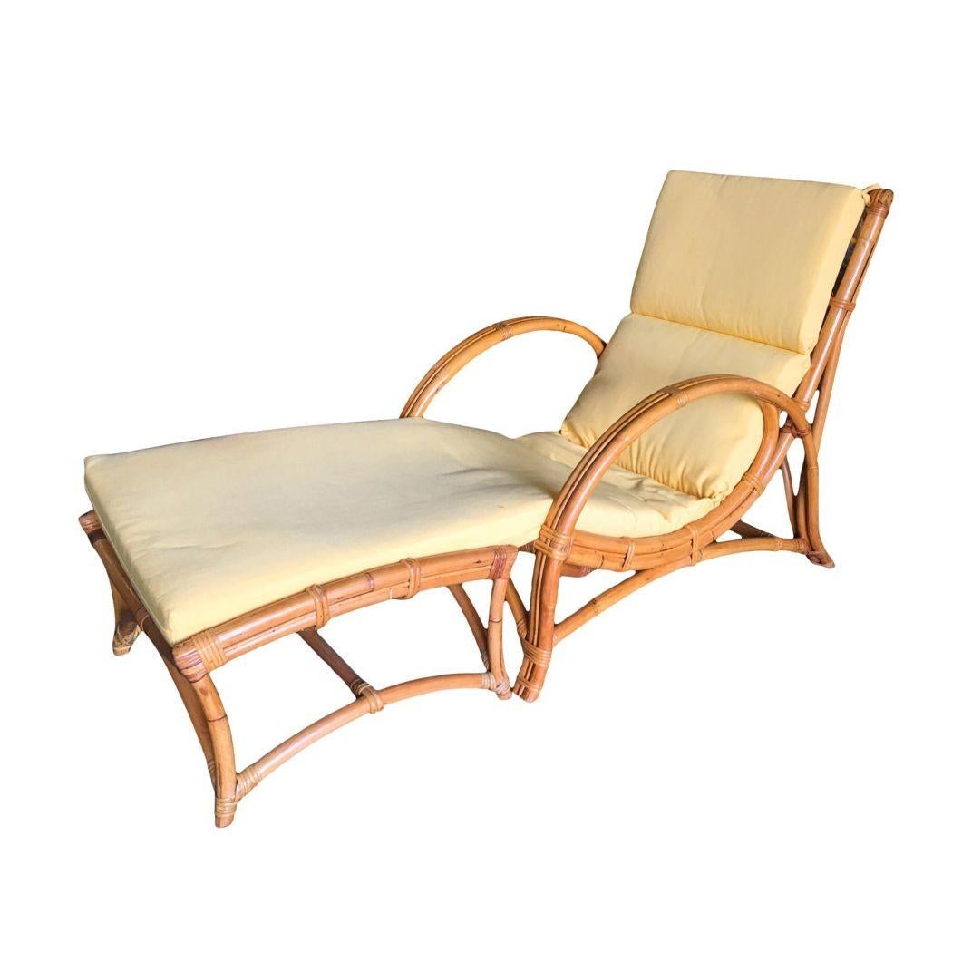 Two-strand slope seat rattan lounge chair with matching ottoman. The chair arms feature 2 full rattan poles bent into an arch with a decorative center stick rattan piece. The seat features a rare heavy slope for a comfortable half-reclined
