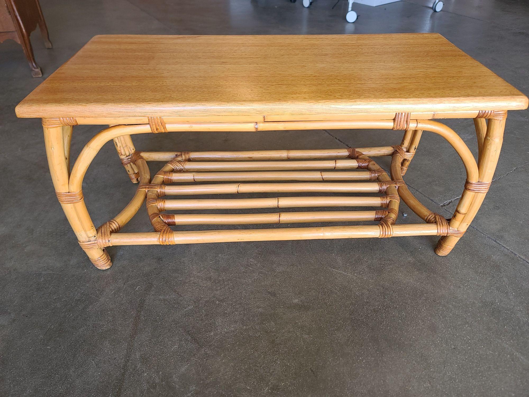 This piece is a vintage 1940s rattan coffee table with a wonderful bentwood base and stylized arches built-in. It also has a beautiful mahogany top. This table is sure to grab attention as a wonderful centerpiece in any room. Also available are a