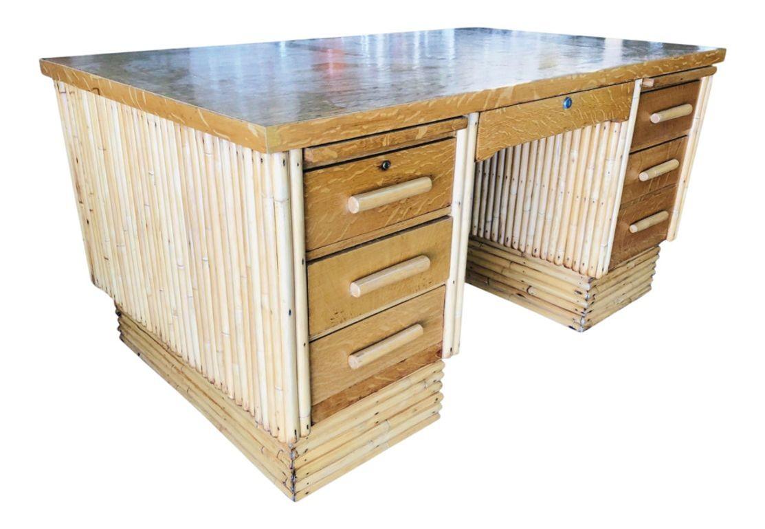 Restored very large stacked rattan desk, with Filipino mahogany top. Drawer fronts, side panels, and top. The desk features a center drawer and six side drawers. Beautiful stacked rattan legs race from the top to the bottom, creating a great modern