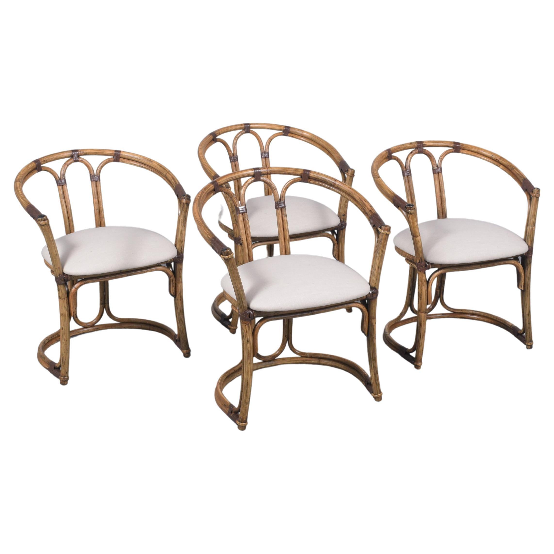 Explore the unique allure of our set of four vintage bamboo barrel chairs, beautifully crafted and thoughtfully restored by our expert in-house professionals. These chairs retain their natural bamboo color, enhanced with rich brown details and a